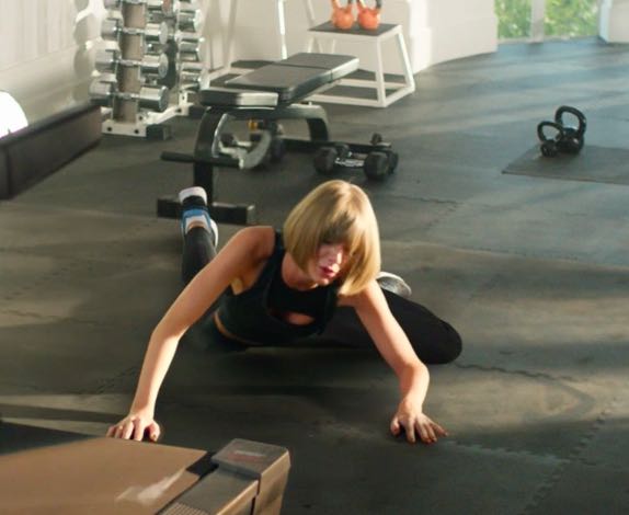 Taylor Swift wipes out on the treadmill in latest commercial for Apple