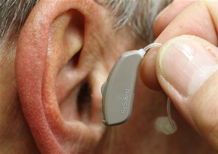 Employee of GN, the world's fourth largest maker of hearing aids, demonstrates the use of ReSound LiNX in Vienna