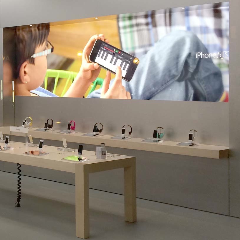 Apple livens up retail stores with backlit wall graphics from TV ads