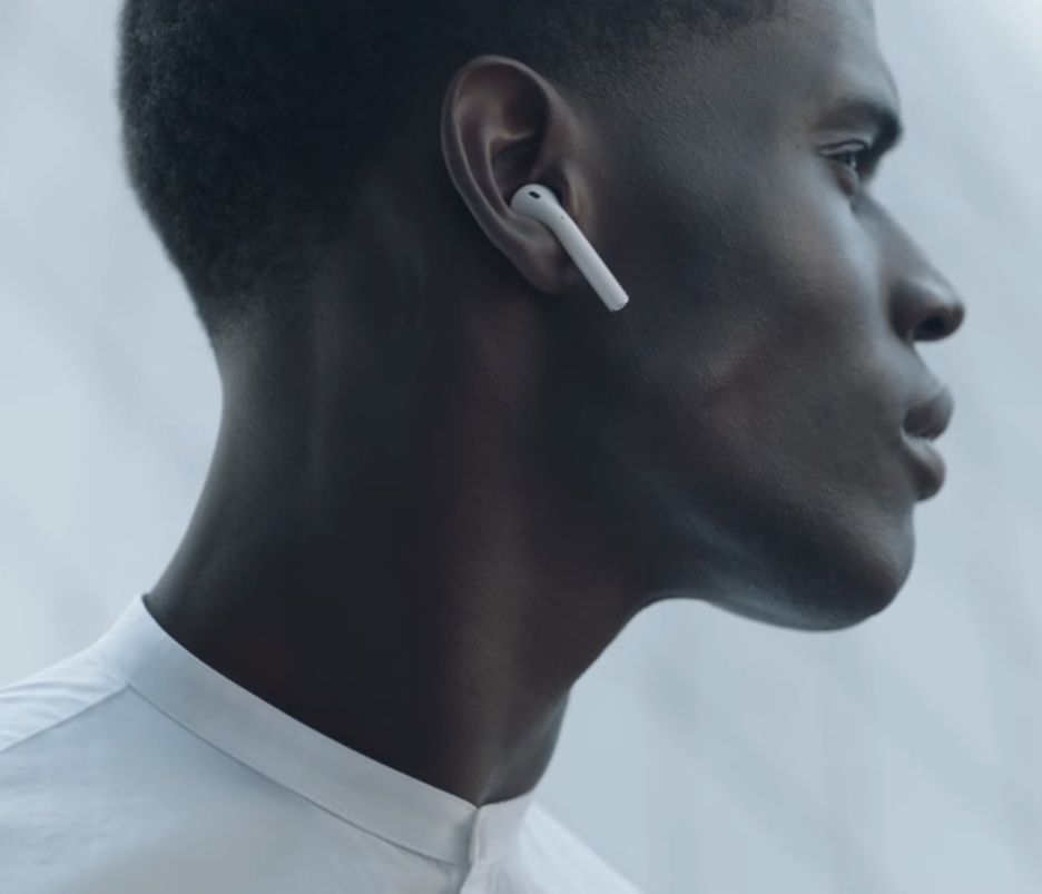 New AirPods features: AN image showing a male model wearing AirPods