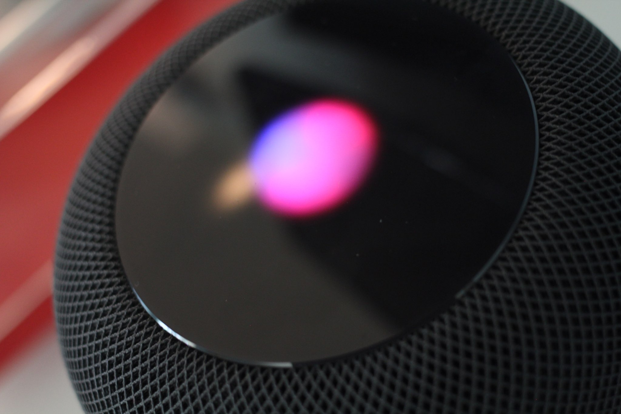 HomePod with purple light on its touch pad