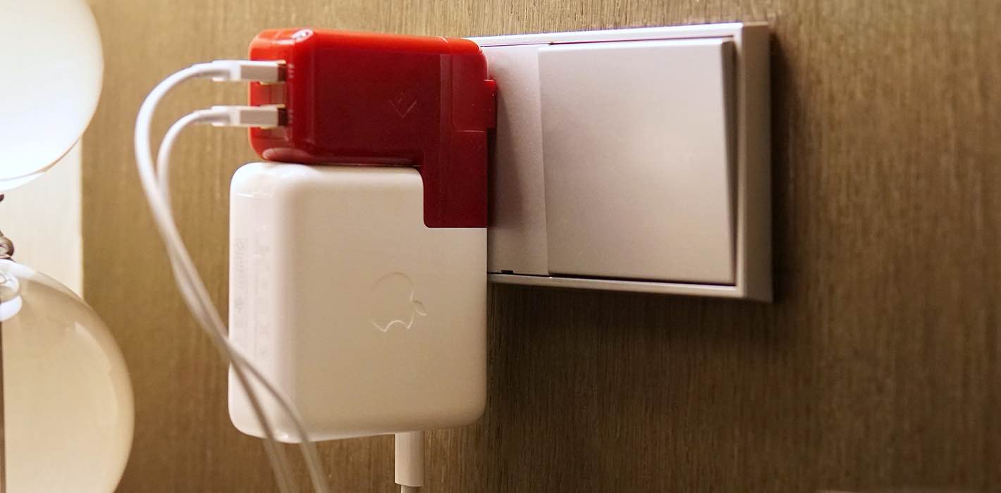 PlugBug Duo from Twelve South shown snapped on a MacBook USB charger and plugged into a wall outlet