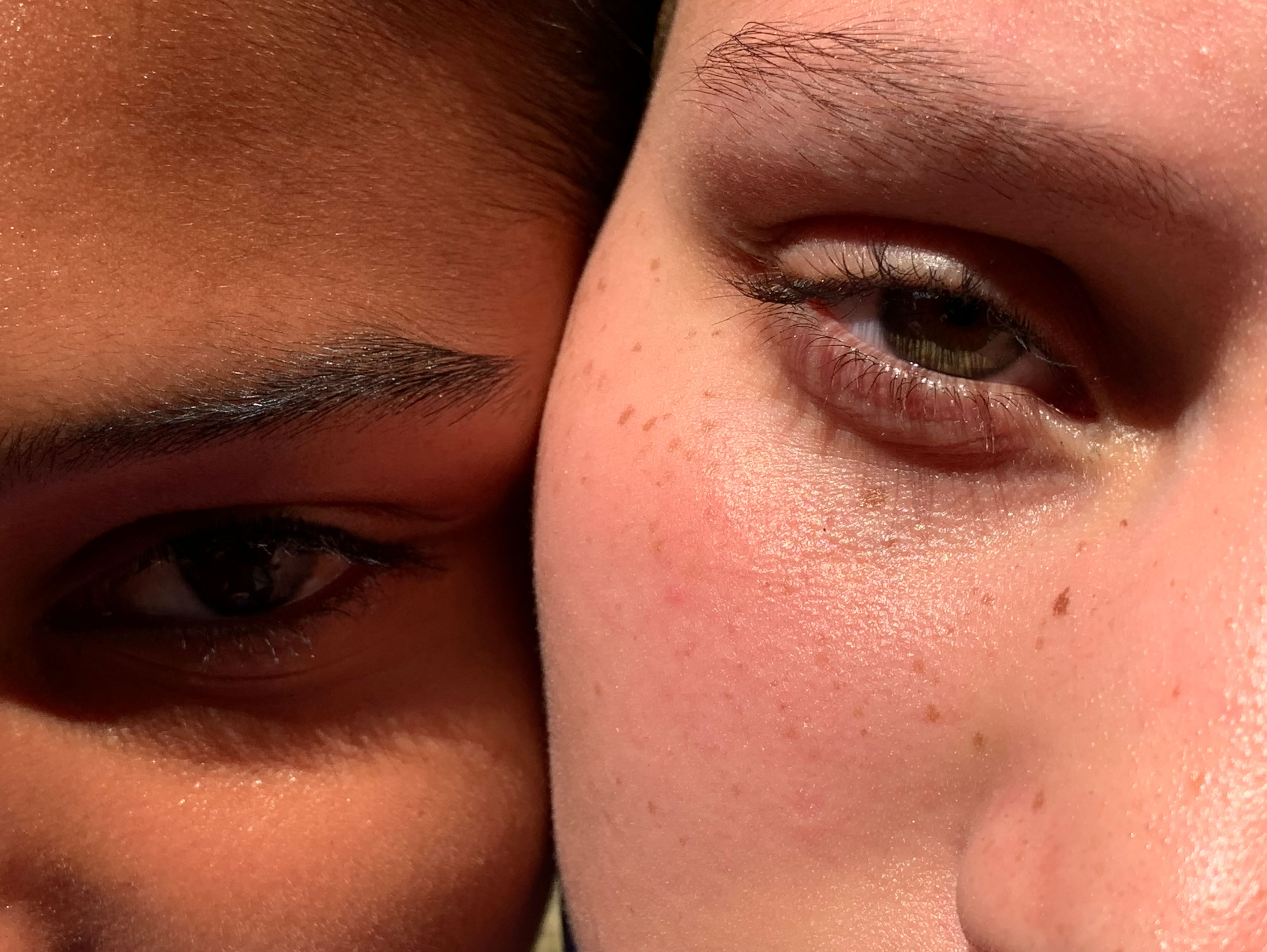 Close-up HDR picture of two women having different skin tones