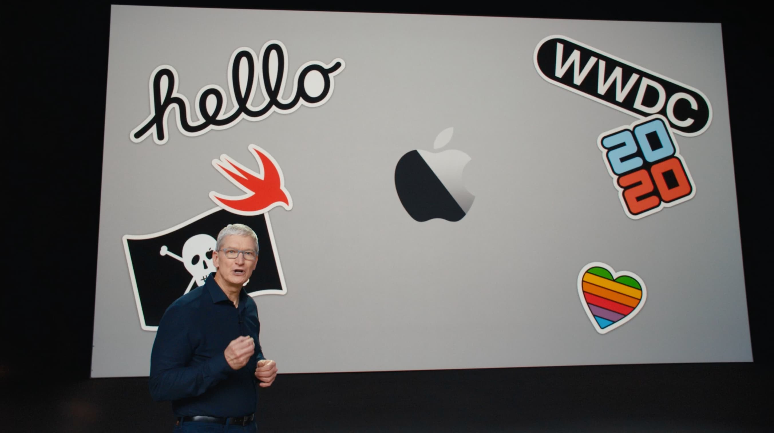 Tim Cook at WWDC 2020 in front of a slide showing a MacBook Air with user decals on the lid