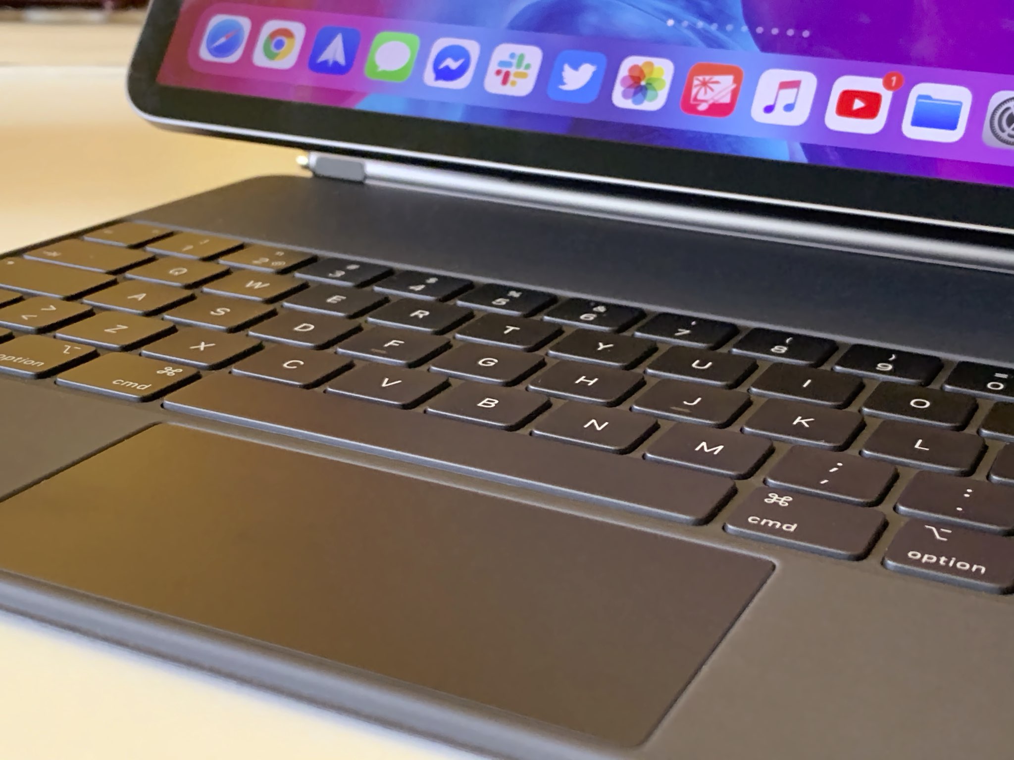 A closeup showing a 12.9-inch iPad Pro suspended on a Magic Keyboard