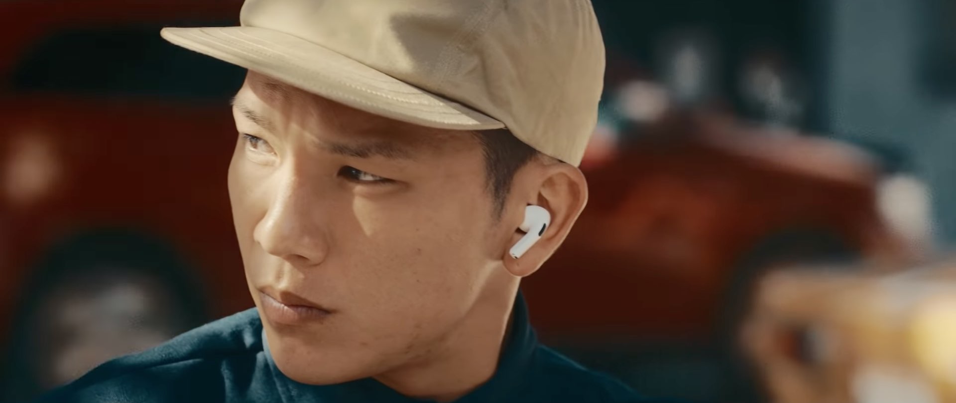 A closeup of a young male's face wearing AirPods Pro in their ears