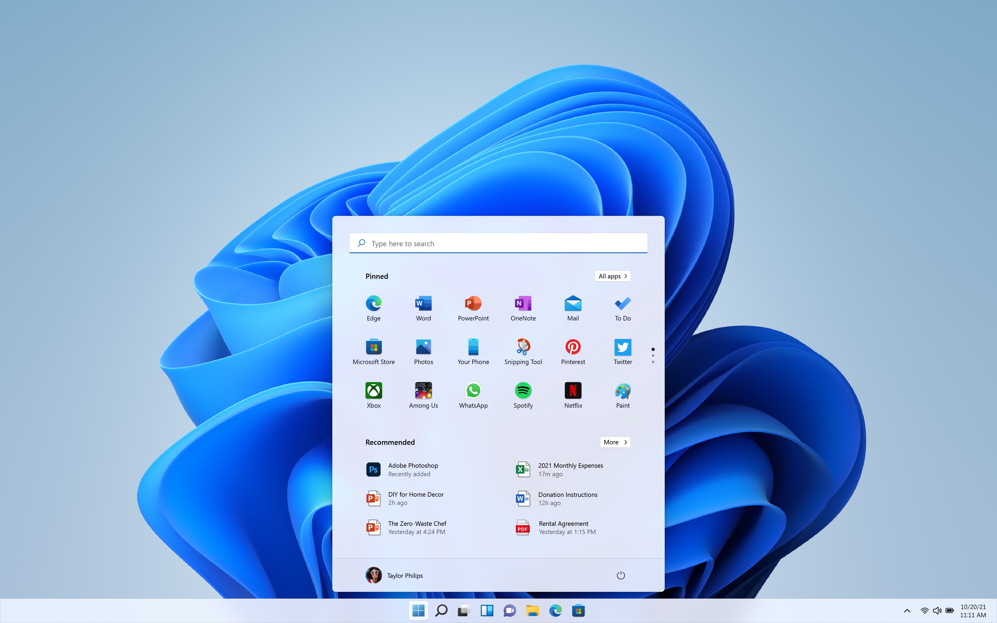 A promotional image from. Microsoft showing the Windows 11 desktop with light theme and the Start menu at the bottom center