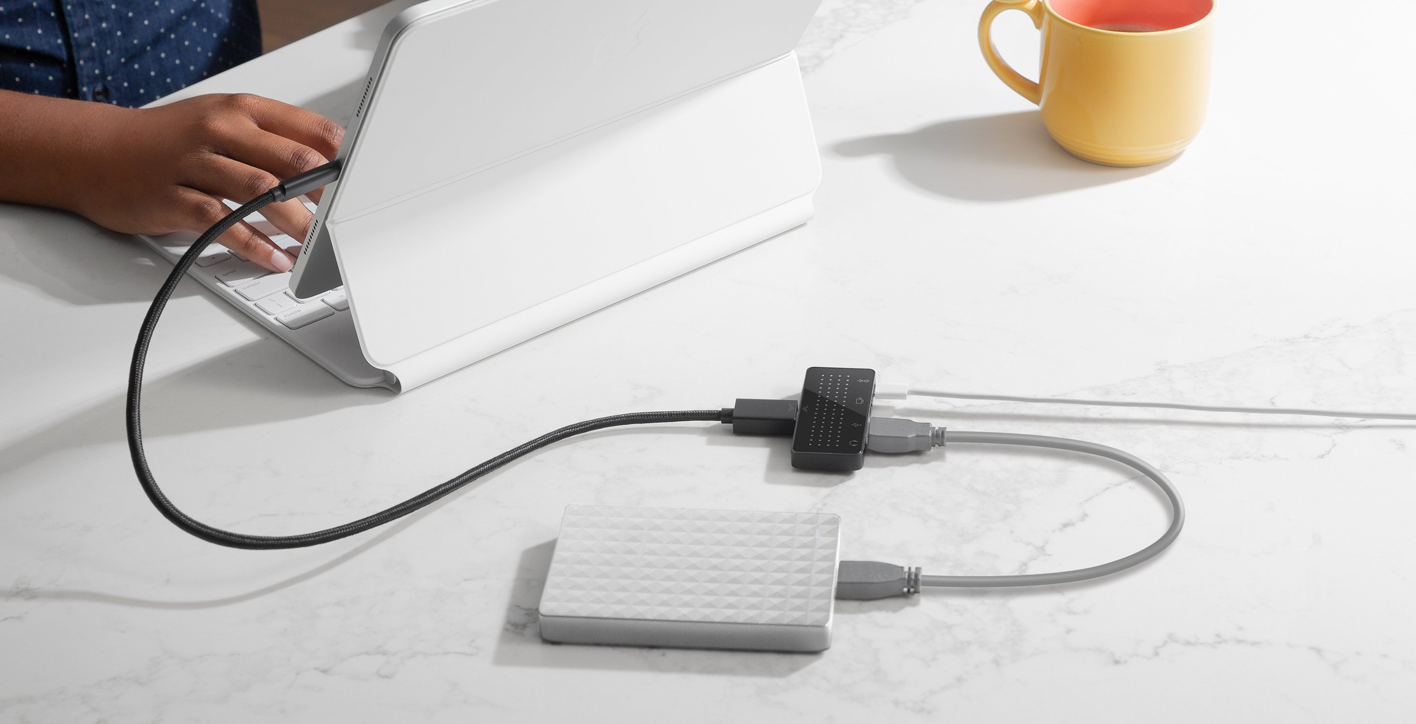 A promotional image from Twelve South showing its StayGo Mini USB-C hub connected to an iPad Air 4