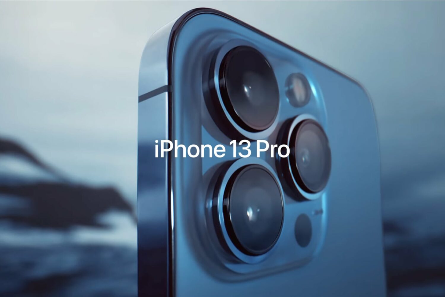 A still image taken from Apple's iPhone 13 Pro introduction video on YouTube, showing a closeup of the three cameras on the back.