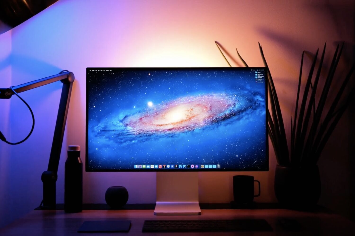 Featured image showing an iMac on a desk with a classic aurora Mac OS X wallpaper set as the desktop background