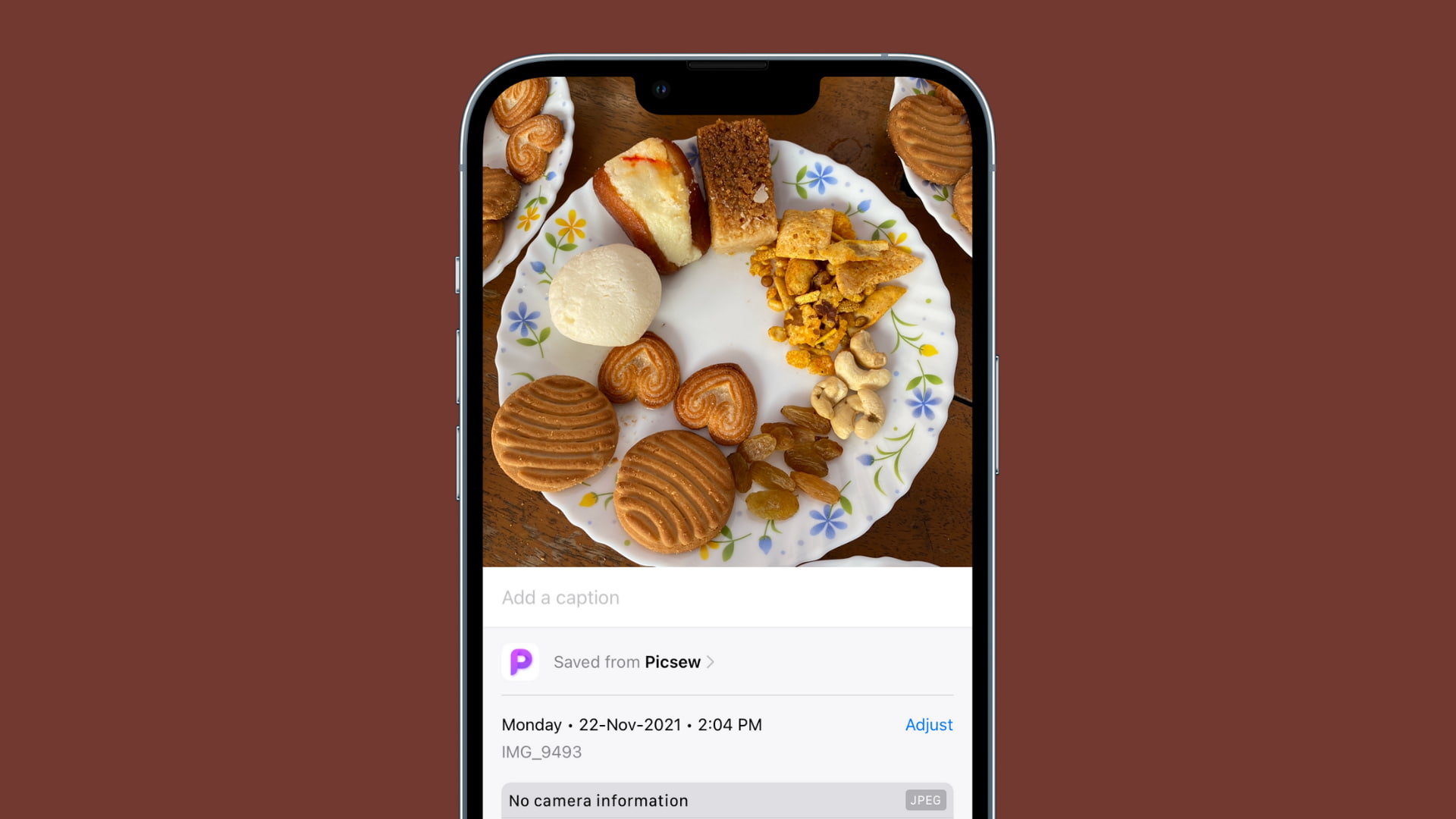 iPhone with sweets on screen with brown background