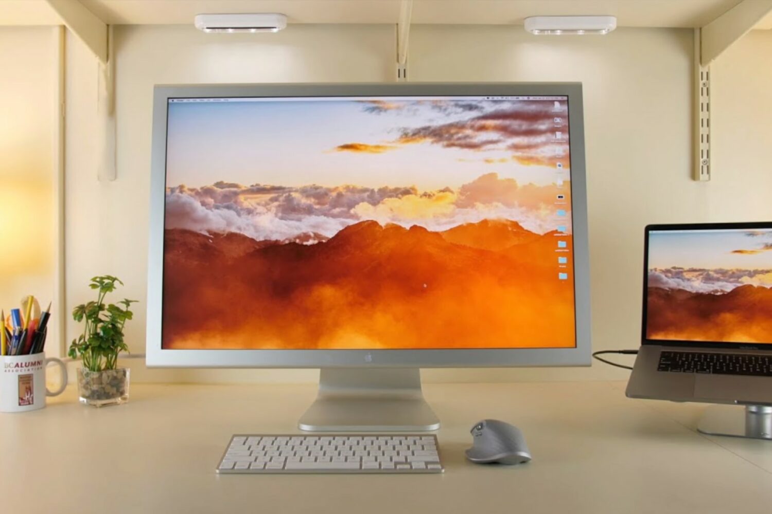 A photograph showing a 30-inch Apple Cinema Display on a work desk next to a MacBook Pro