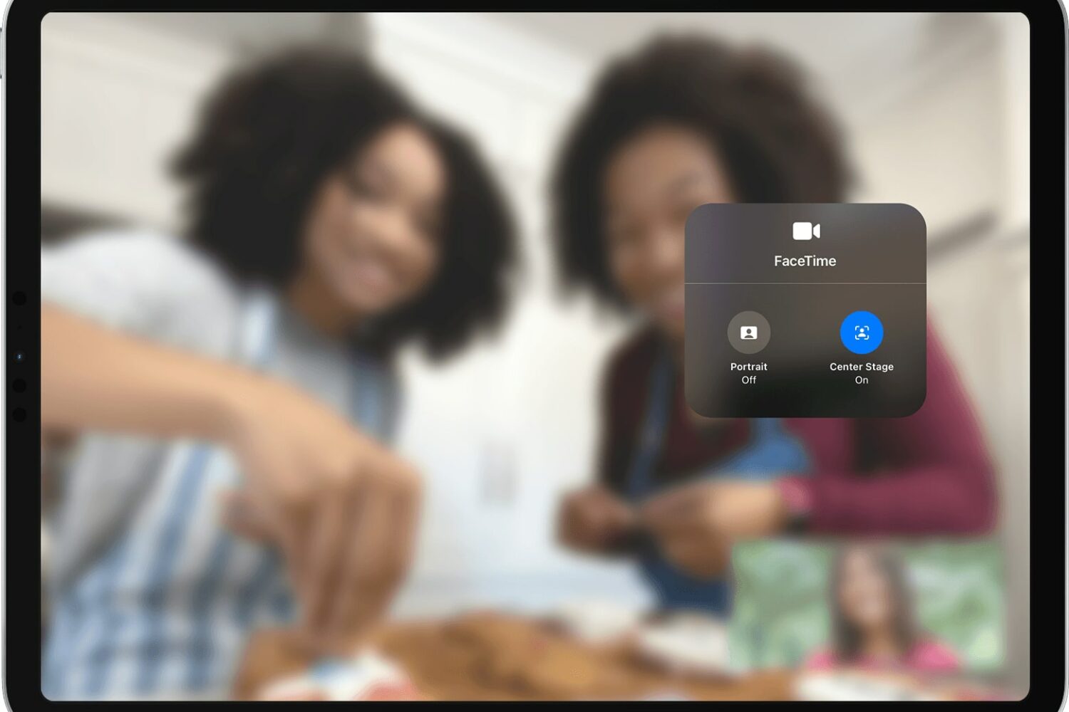 Apple's marketing image showing the iOS 15 Control Center overlay on iPad Pro with the Center Stage camera feature selected in the Video Effects menu, and a blurred FaceTime video call in the background