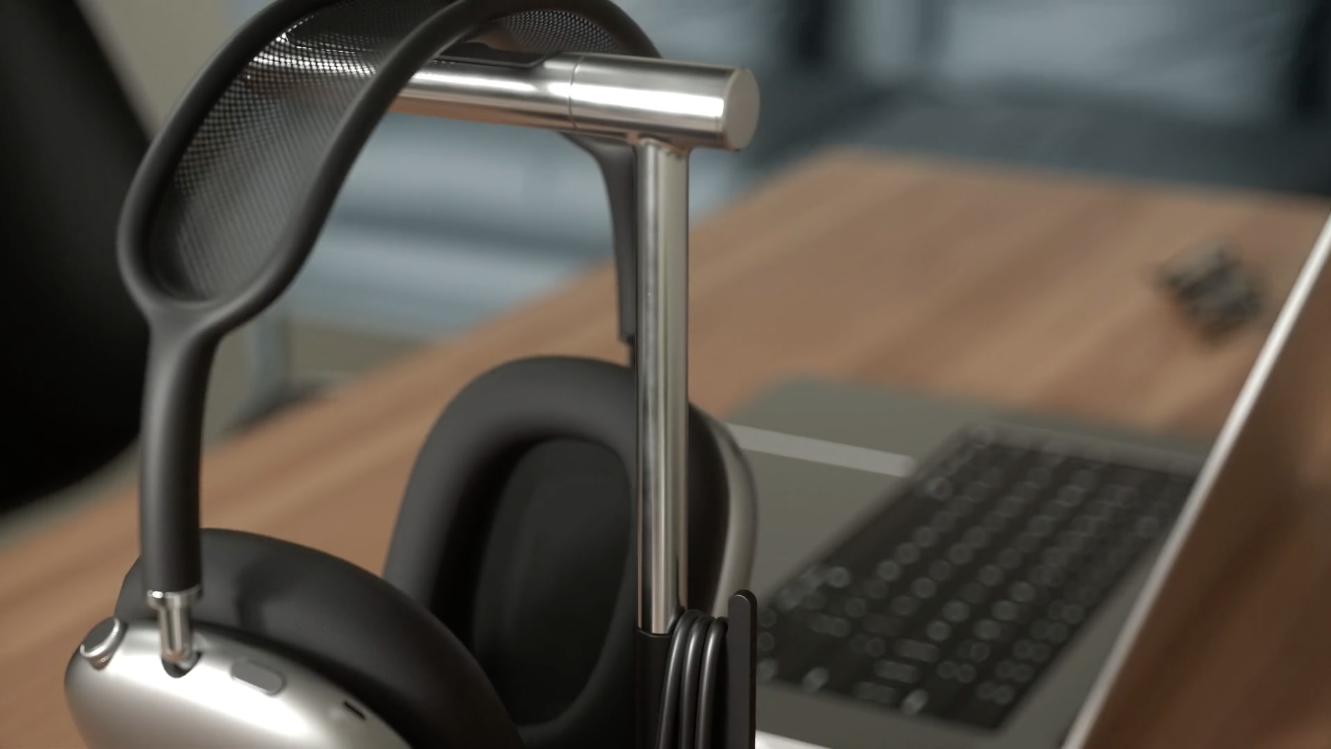A still image from Satechi's promotional video showing the top of its 2-in-1 Headphone Stand with Wireless Charger with AirPods Max resting on it