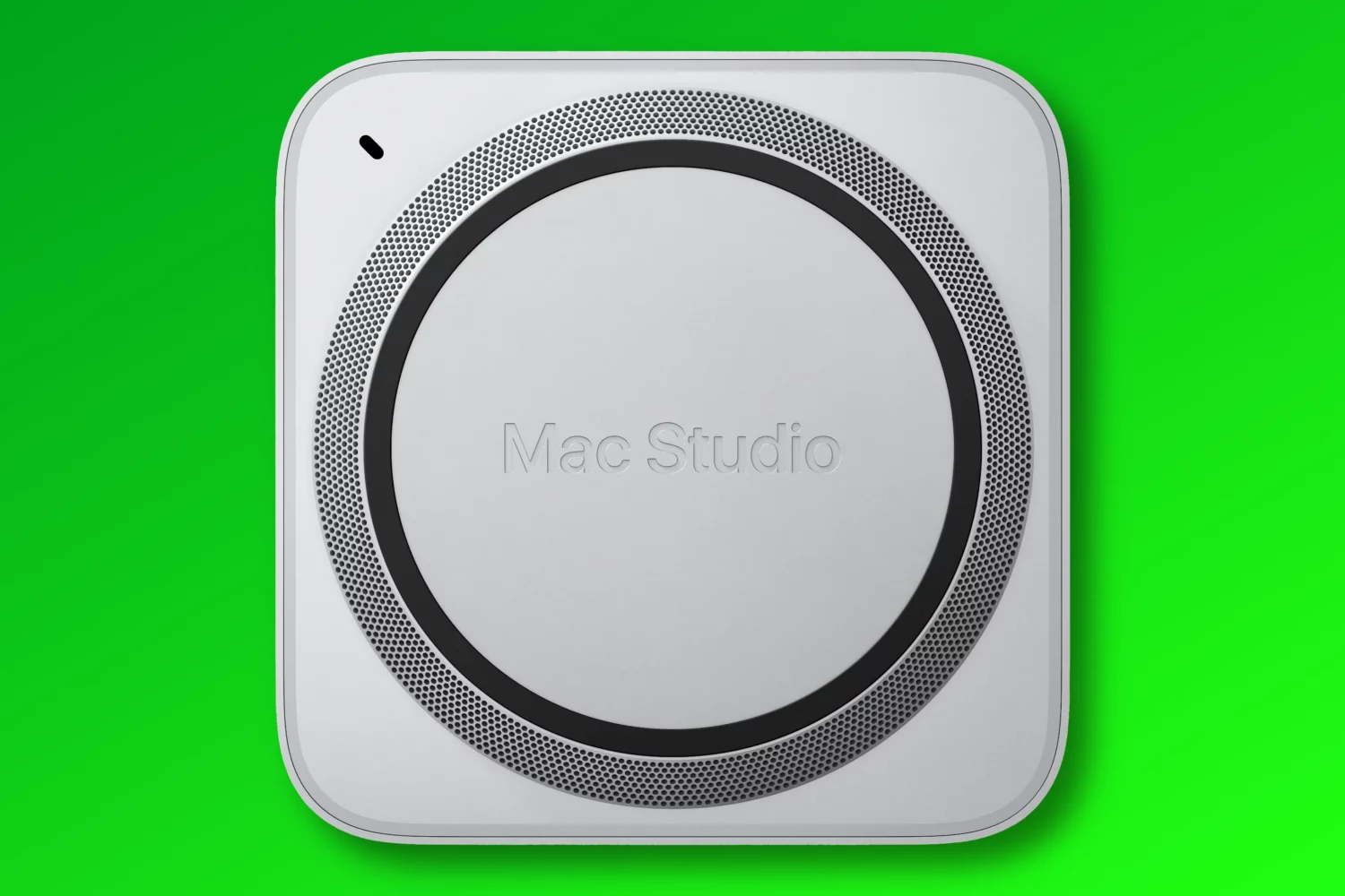 An image showing the bottom of Apple's Mac Studio desktop computer with a hole in the top left corner for a secure lock adapter, set against a blue gradient background
