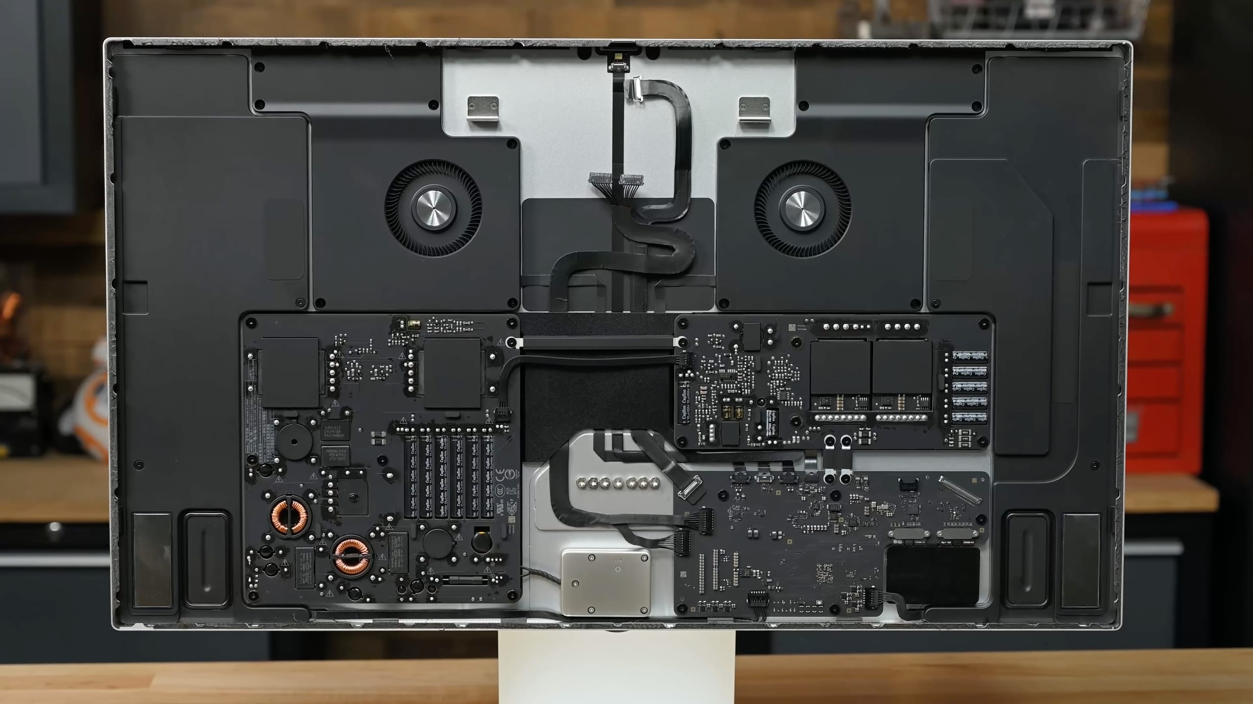 A still from iFixit's teardown video showing the internals of the 27-inch Apple Studio Display with its 5K Retina LCD panel removed