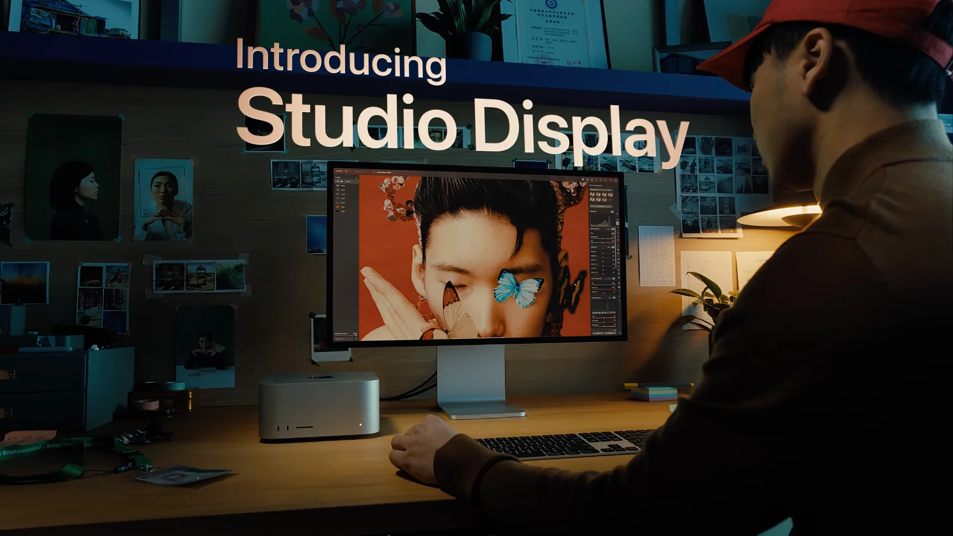 A still image from Apple's commercial for the Studio Display showcasing a creative professional editing an illustration on their Mac Studio and Studio Display, with the tagline "Introducing Studio Display" displayed near the top of the image