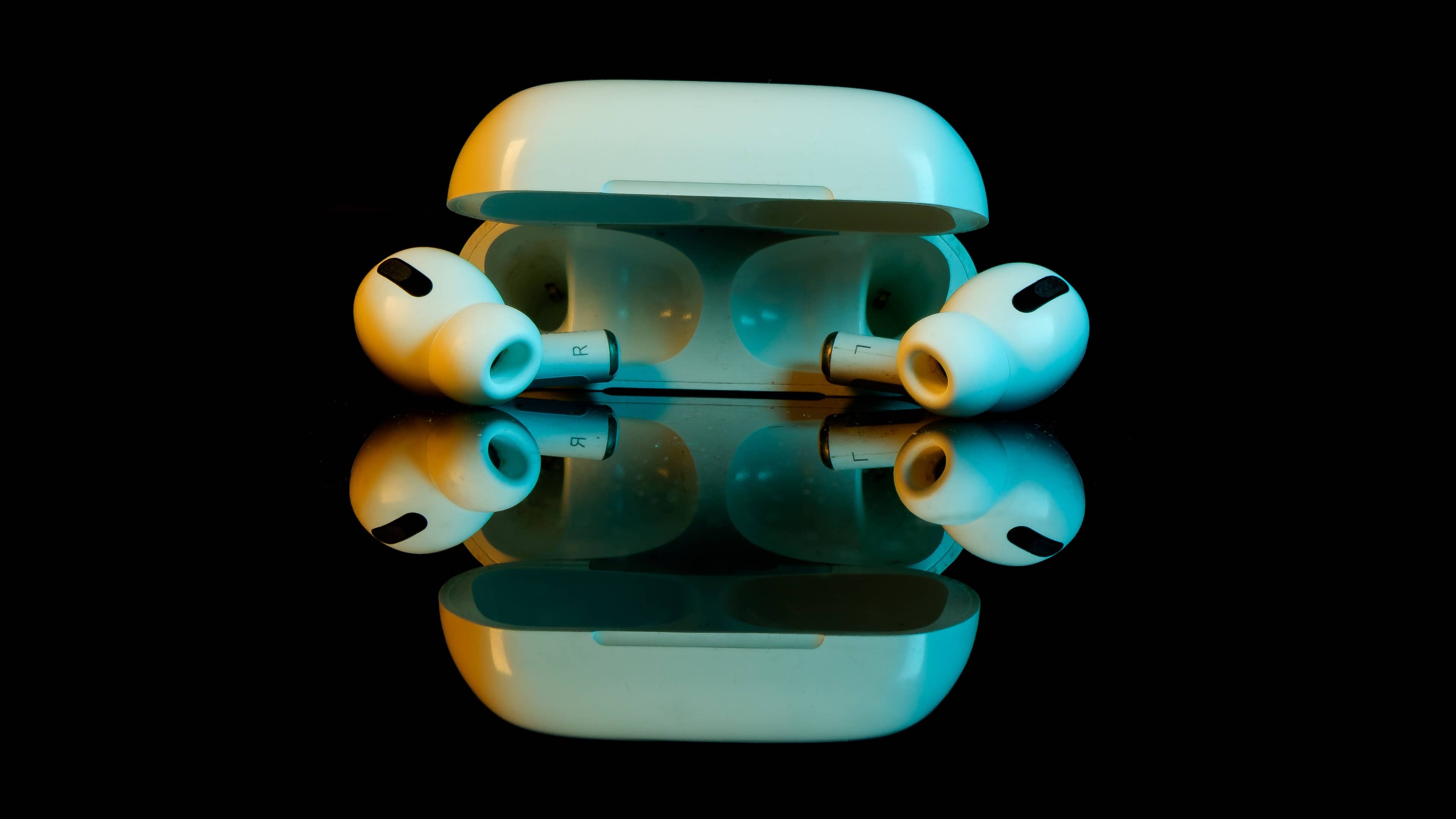 A photograph showing a top-down view of an AirPods Pro case with the lid open and both earbud in the case