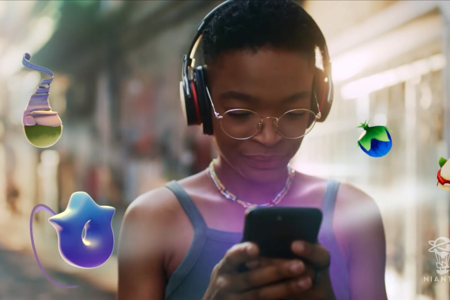 A young girl playing the AR pet simulator Peridots on her iPhone can be seen in this still taken from Niantic's official teaser