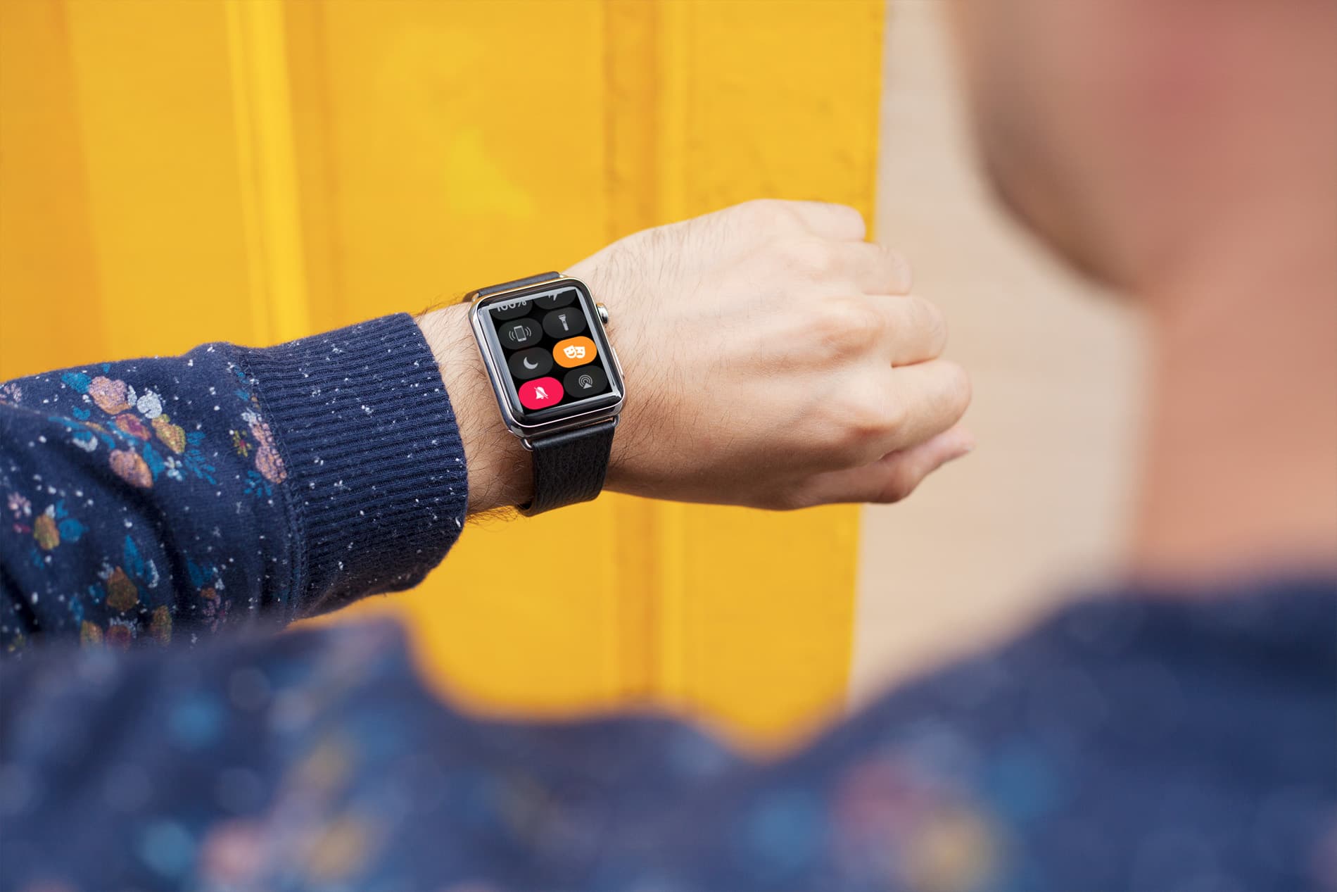 A person wearing Apple Watch with Theater Mode enabled on it