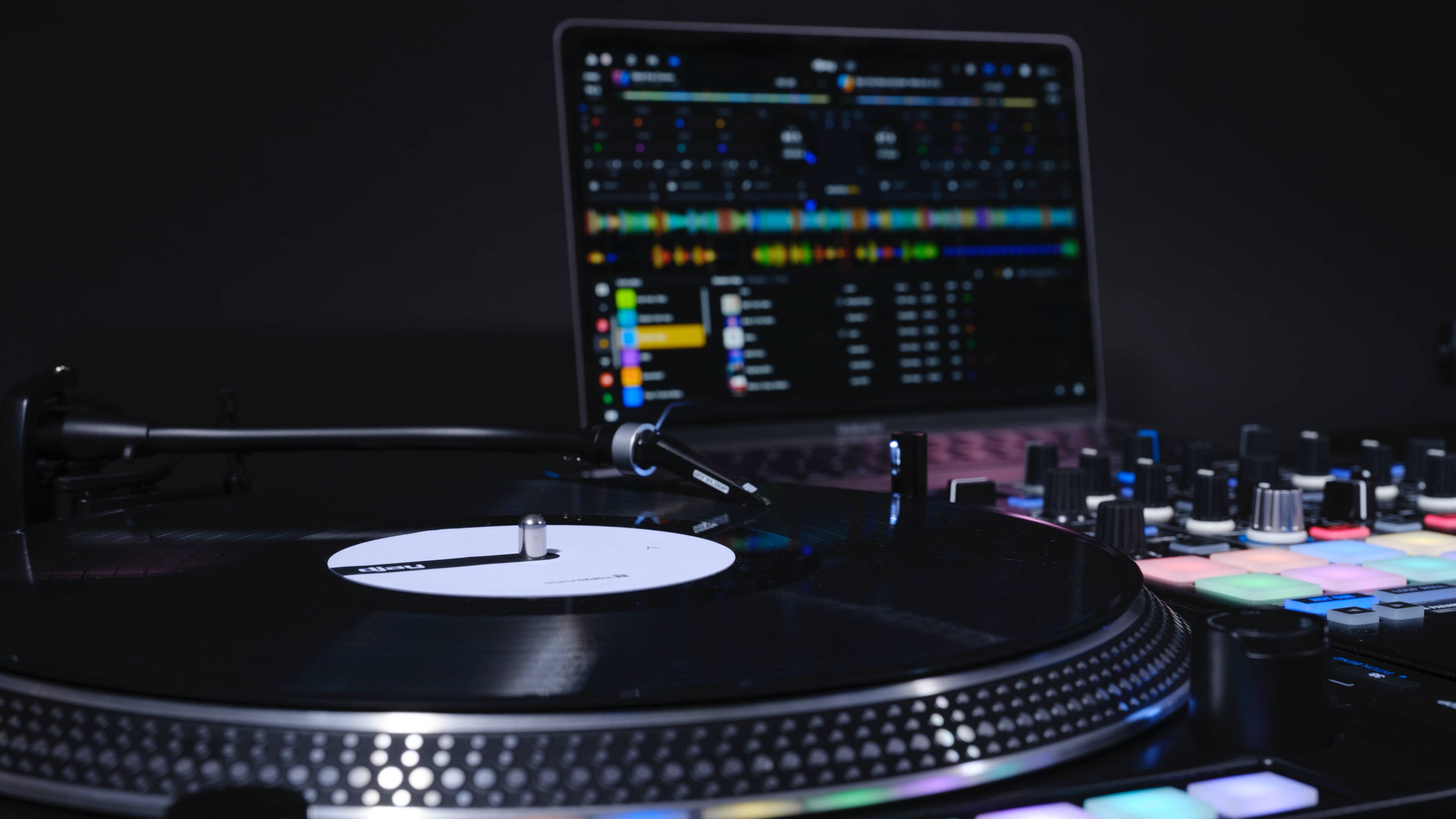 Promotional image showcasing the digital vinyl system in Algoriddim's djay Pro and using a connected professional analog turntable to control the app