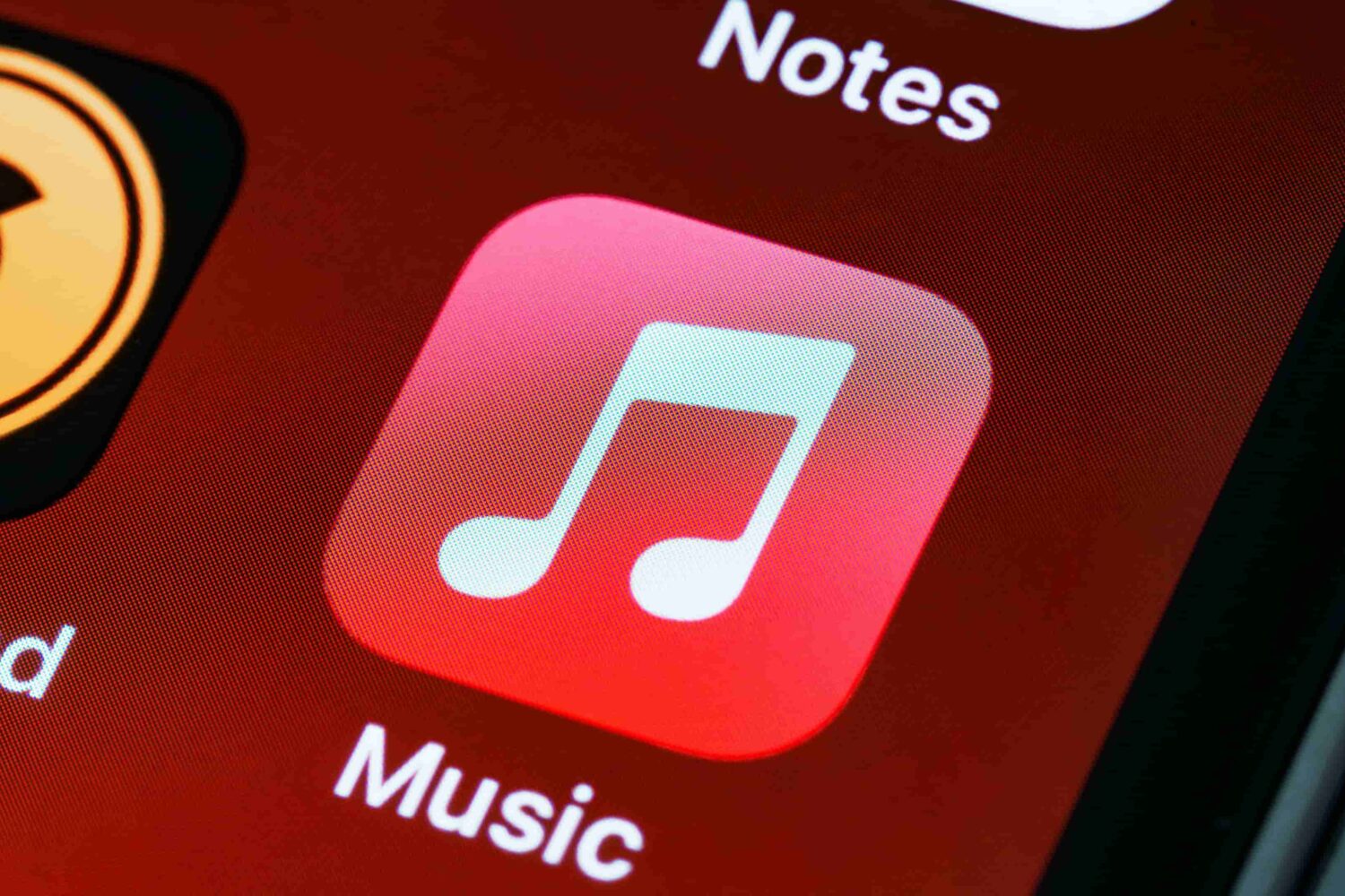 The icon for Apple's Music app is displayed on the home screen of an iPhone in this close-up photograph