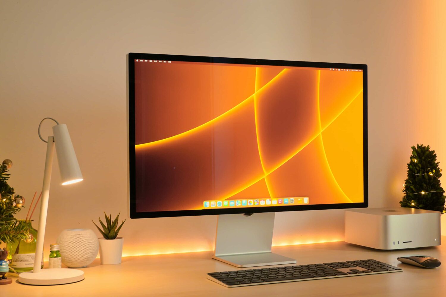 Apple's Studio Display and Mac Studio are featured sitting on a work desk in this lifestyle photograph