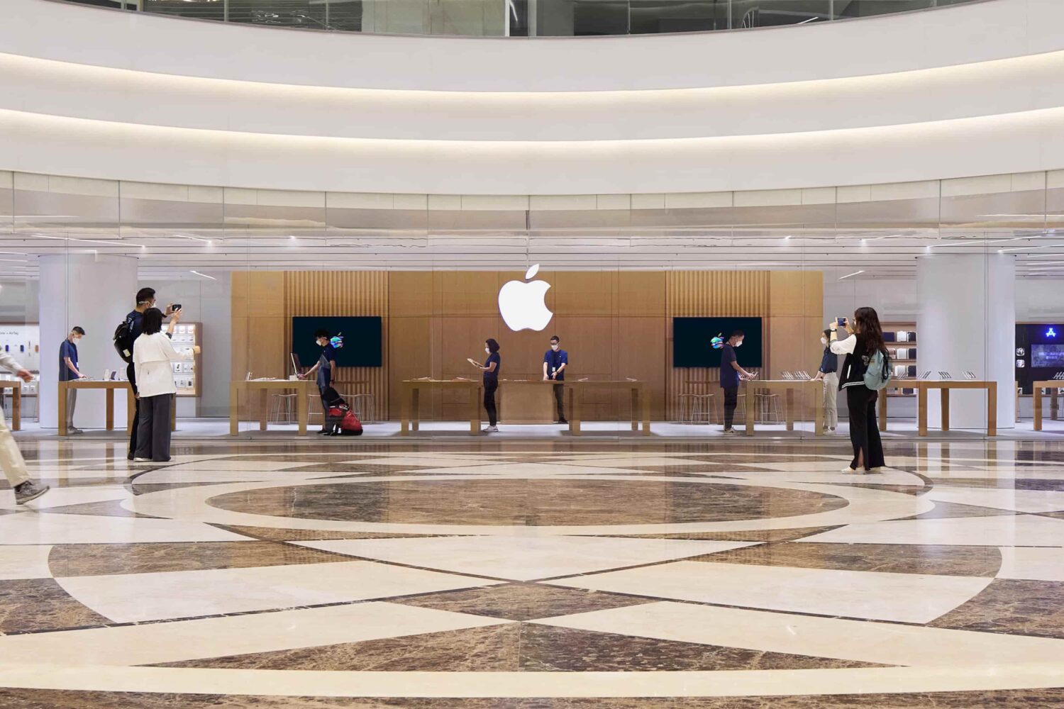 The interior of Apple Wuhan, the company's first store in China's Hubei Province and its 54th retail location in Greater China, is shown in this press photo from Apple, featuring granite floors and wood walls which make the interior brighter and transparent