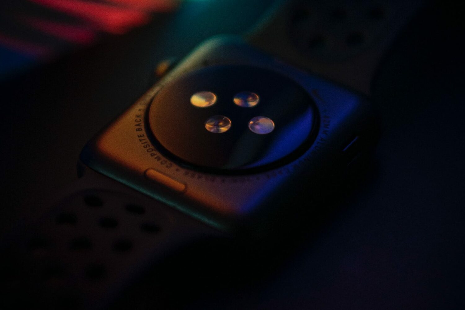 Apple Watch Series 7 laid facedown, with the optical heart rate sensor on its back crystal exposed