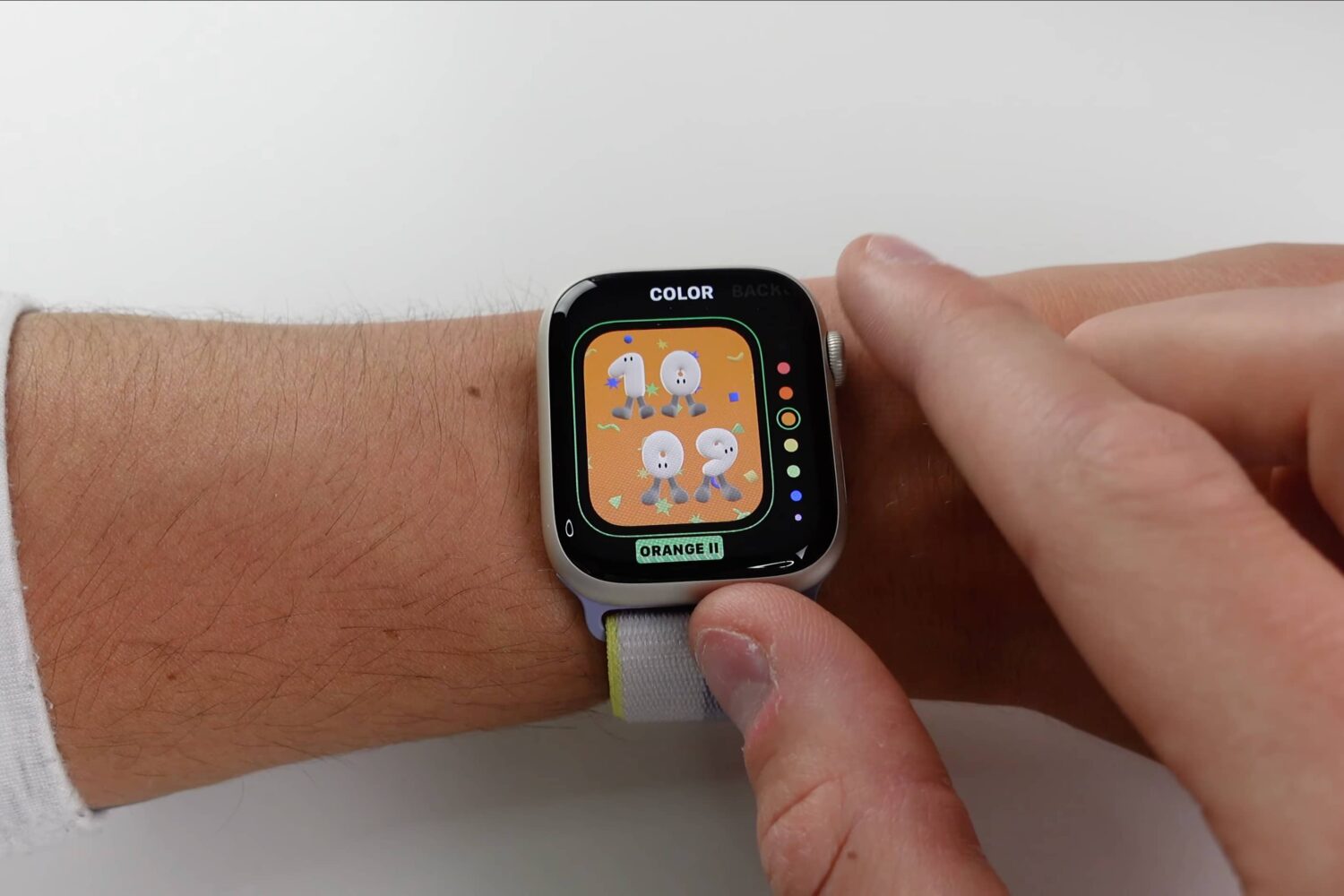 A young person interacts with the new Playtime watch face in the watchOS 9 update using an Apple Watch Series 7 on their wrist