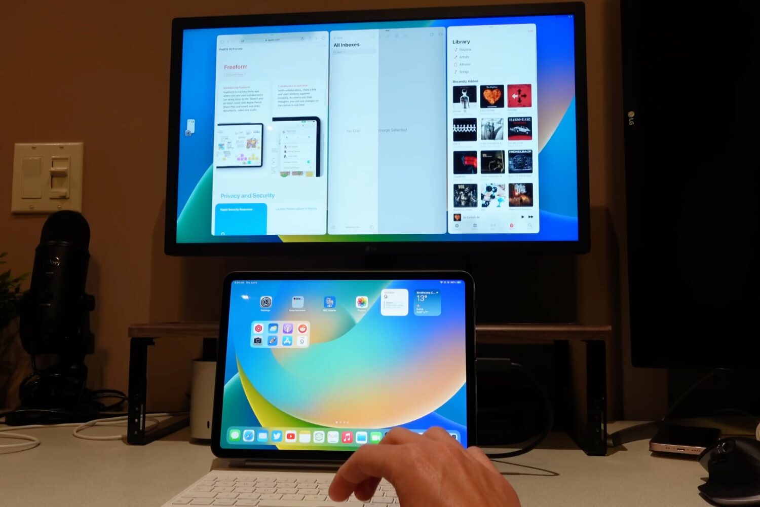 An iPad connected to an external monitor running three apps at once using Apple's Stage Manager multitasking feature in iPadOS 16