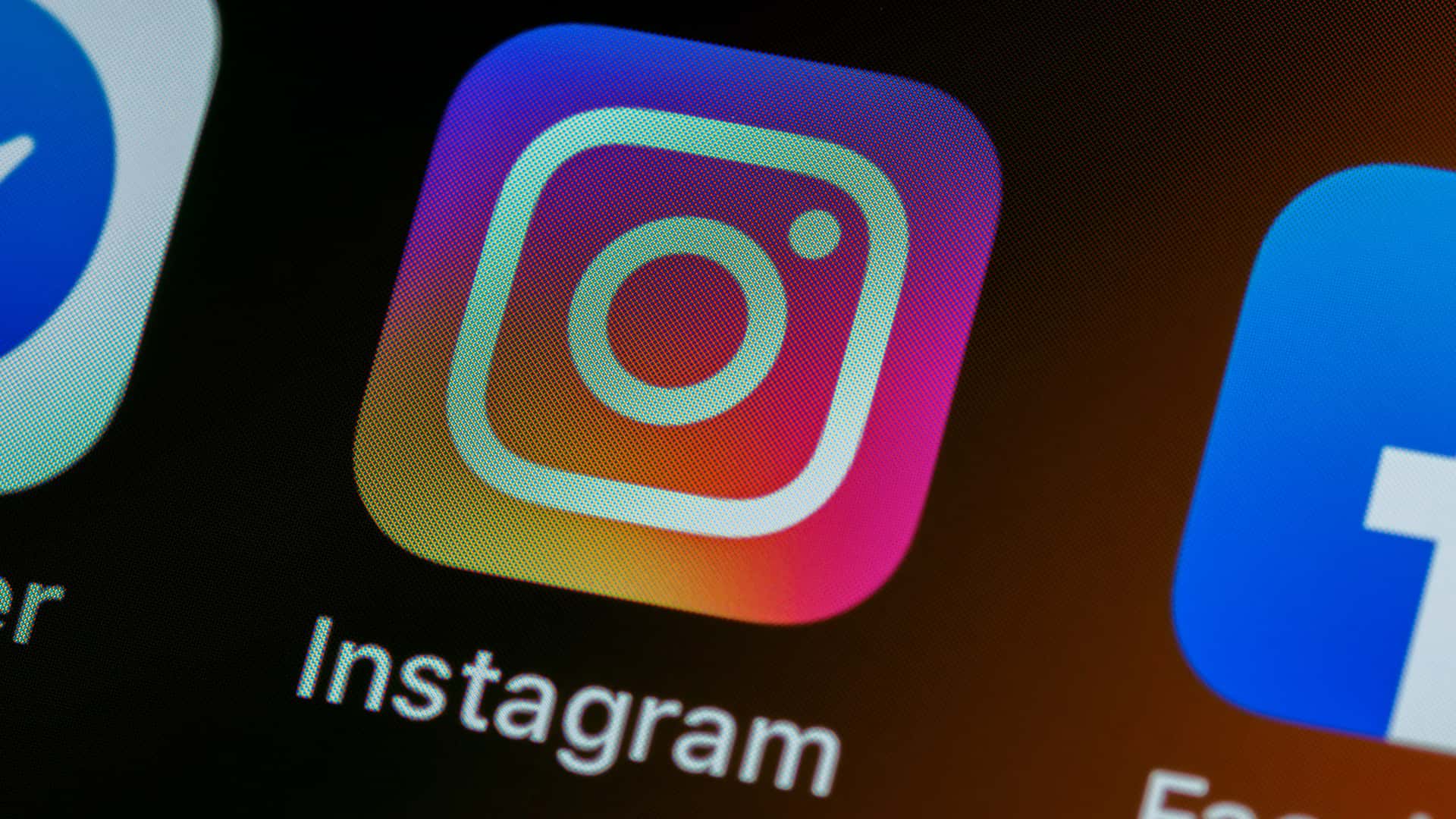 A closeup of the Instagram app icon on the home screen of an iPhone