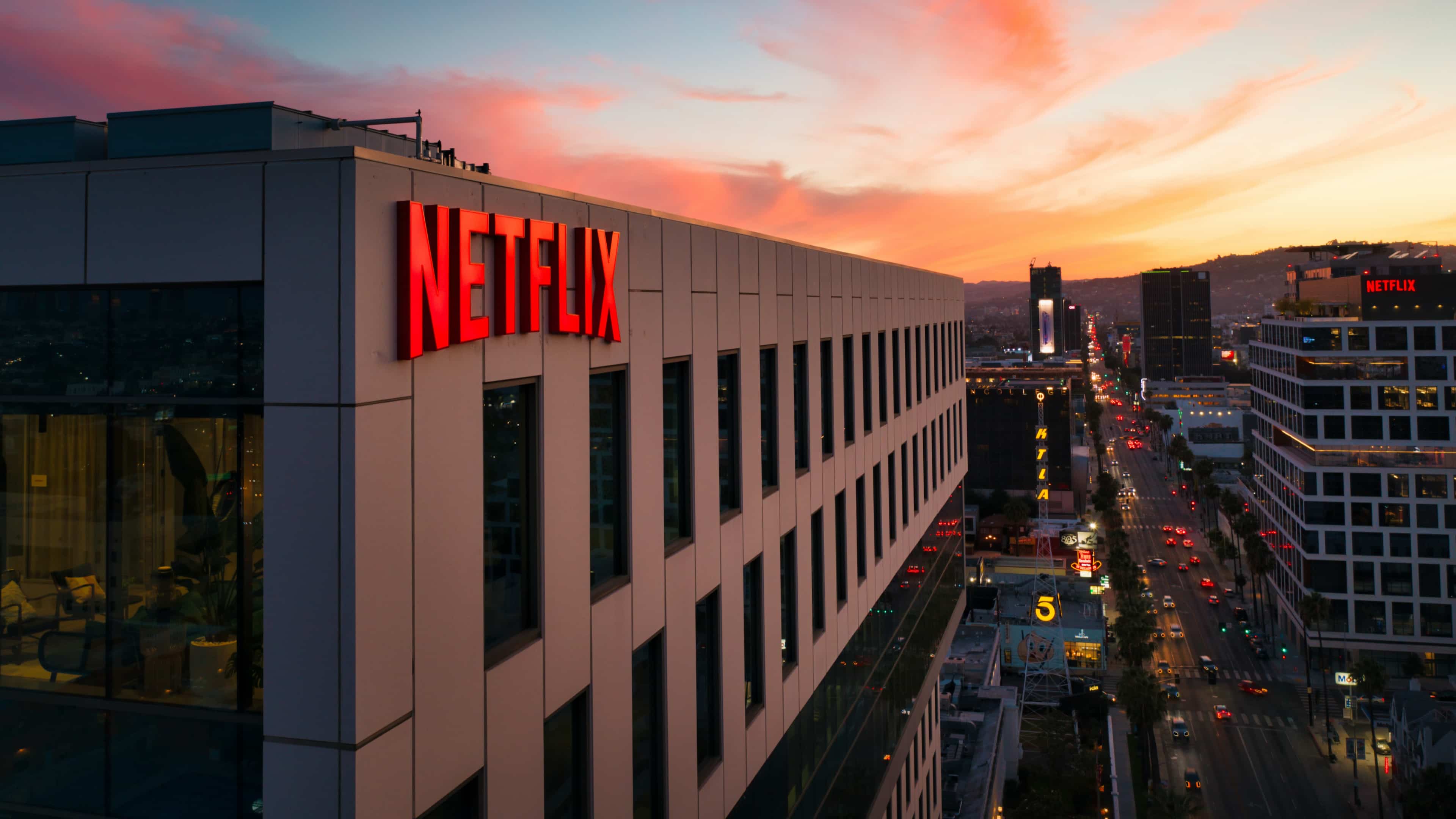 A Netflix logo sign on a building in Hollywood, Los Angeles at sunset