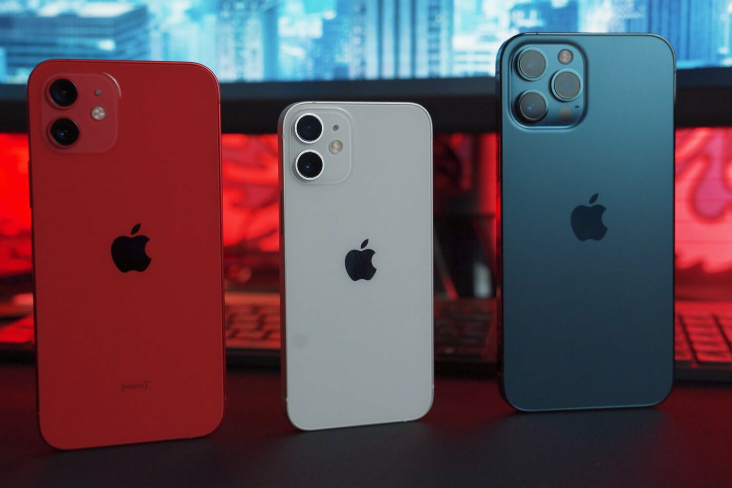 Three iPhones side by side, showing their backs
