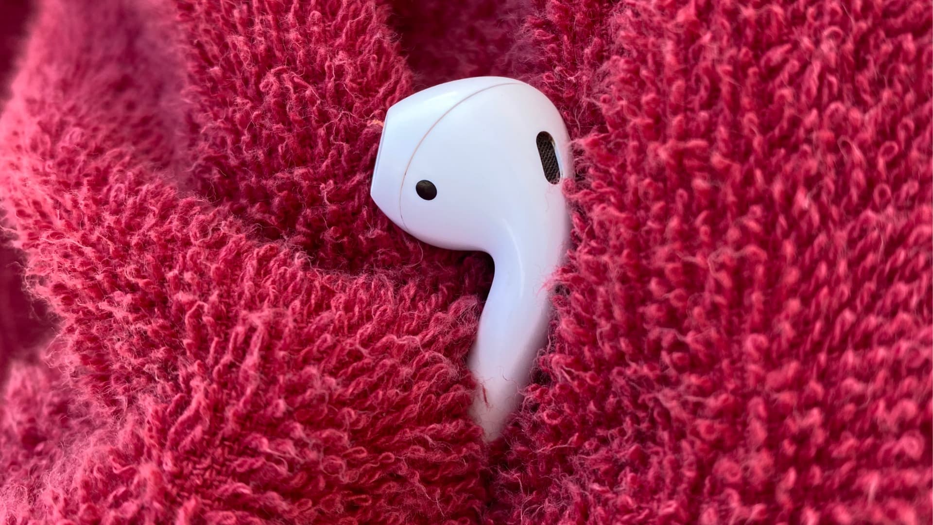 Wiping wet AirPods with a towel to get rid of water