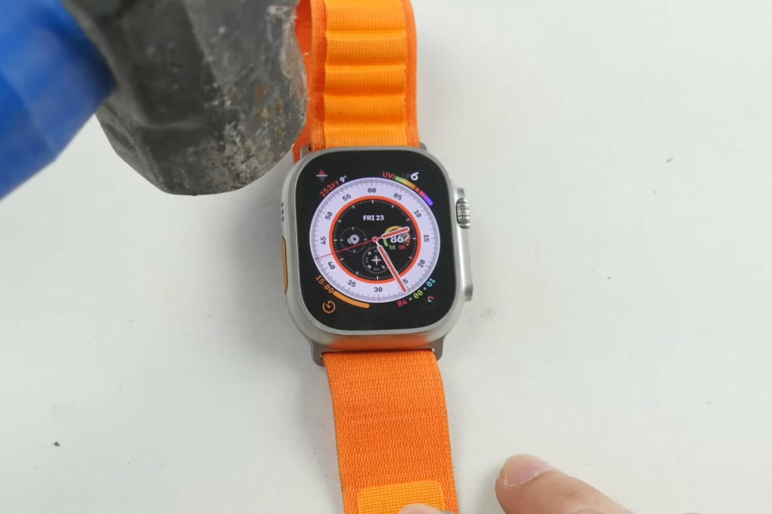 Apple Watch Ultra being hit on the front sapphire cover glass with a heavy hammer