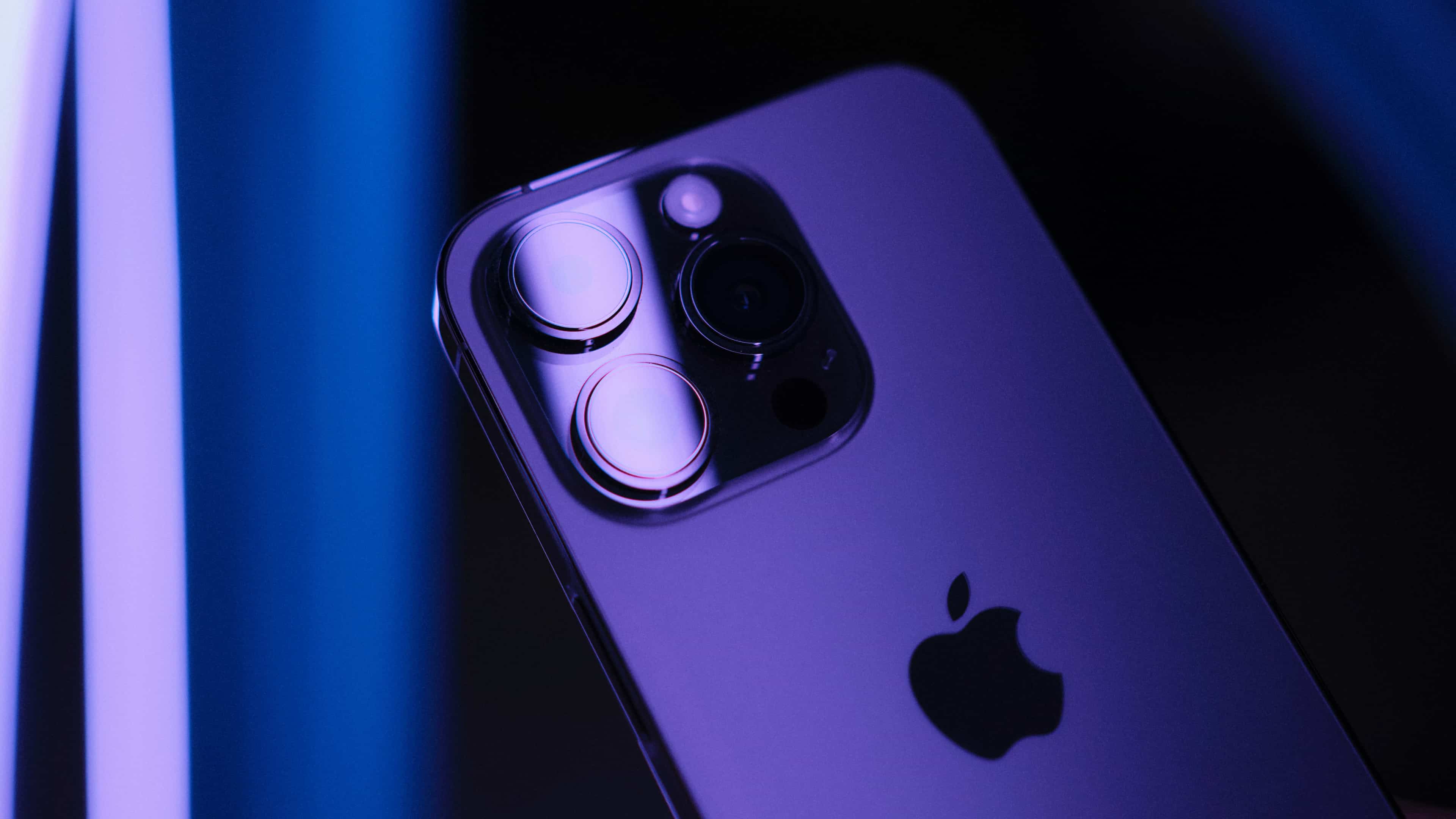 Close-up of the back cameras on deep purple iPhone 14 Pro.