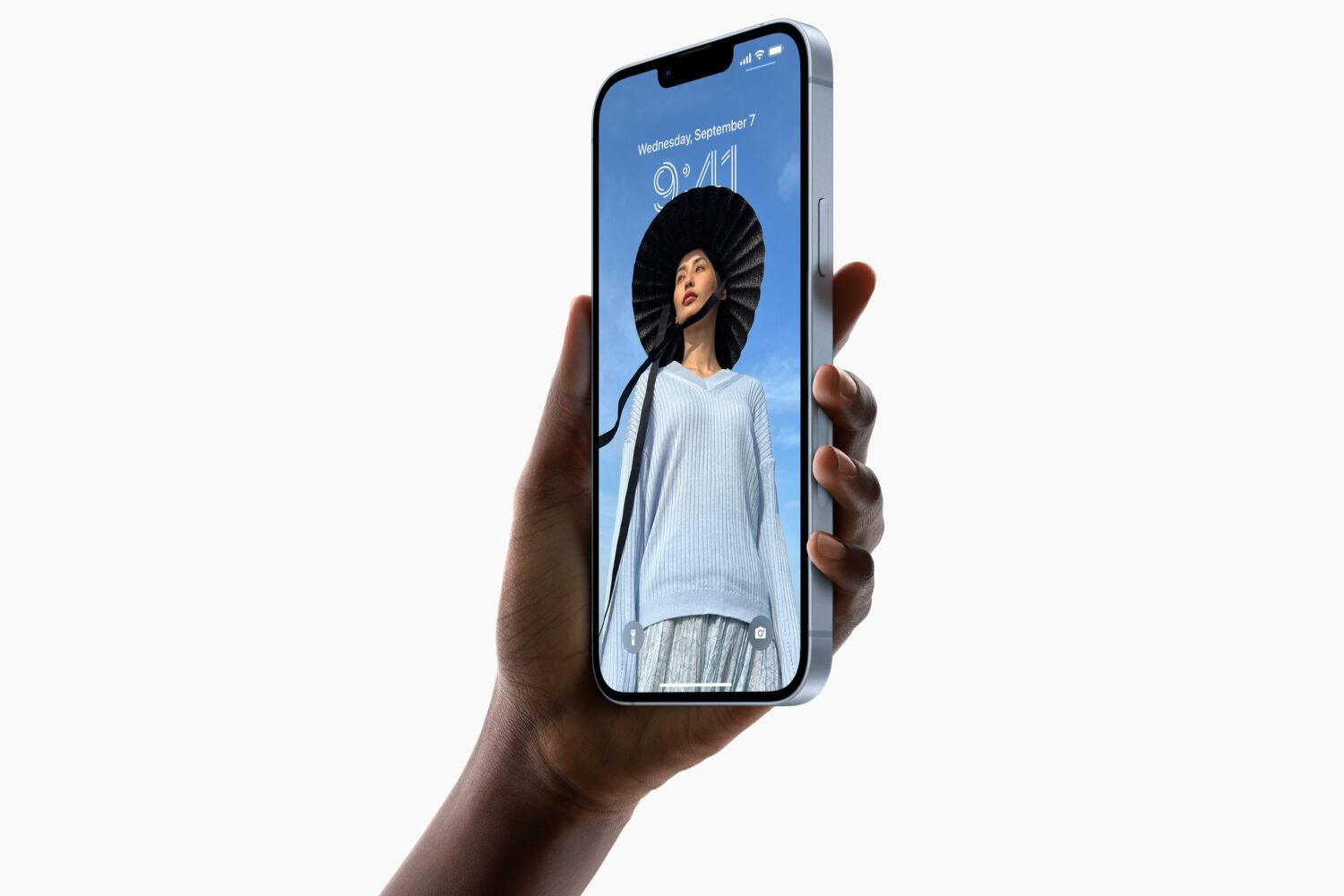 Blue iPhone 14 Plus held in hand, with the lock screen active