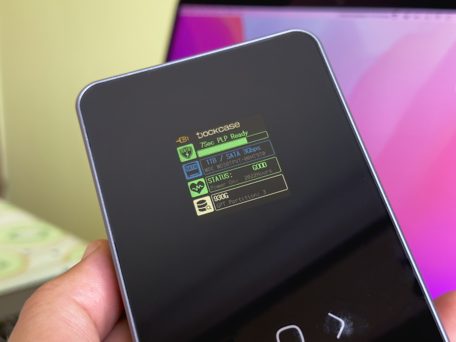 Closeup showing the built-in screen of the DockCase external storage enclosure displaying smart HDD info in real time