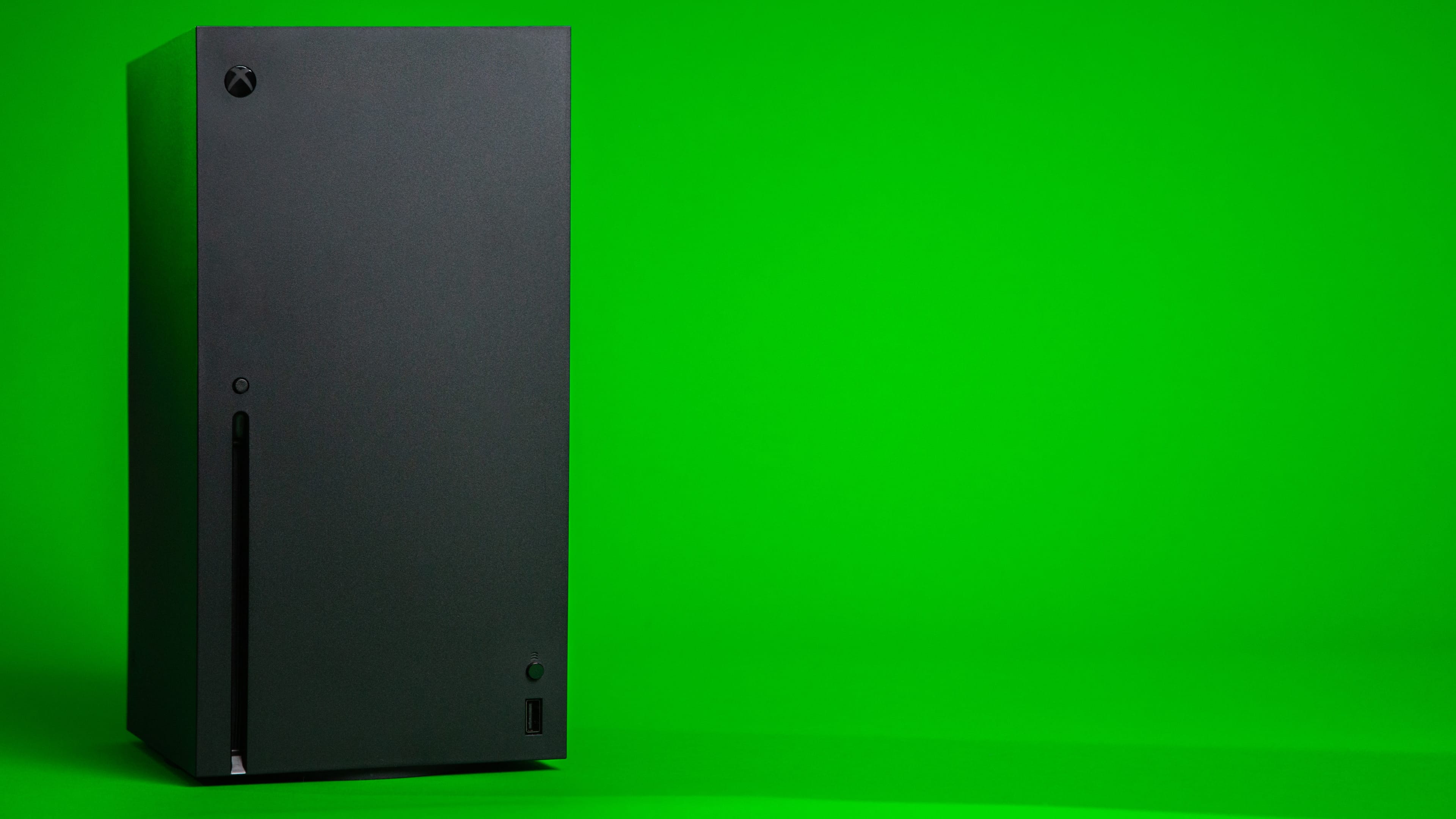 Microsoft's Xbox Series X console in an upright position, set against a green backdrop