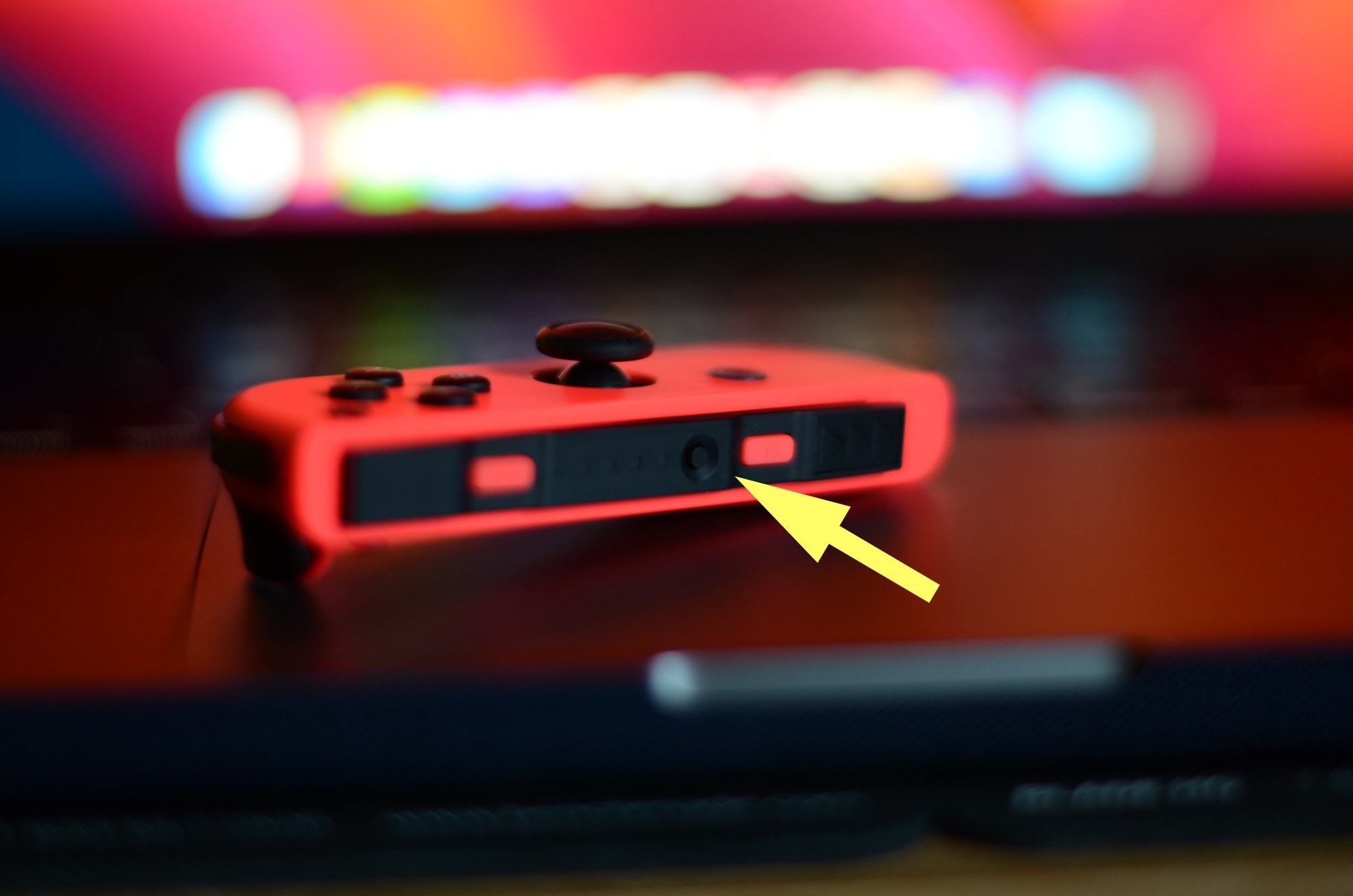 Press and hold the Nintendo Joy Con's pairing button.