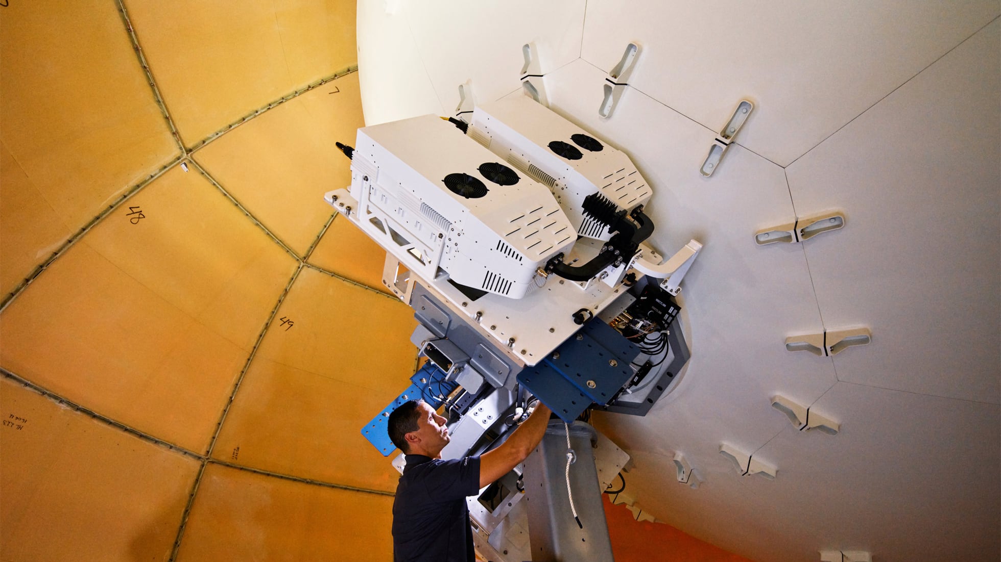 A technician installing equipment inside Globalstar's ground station for satellite communications