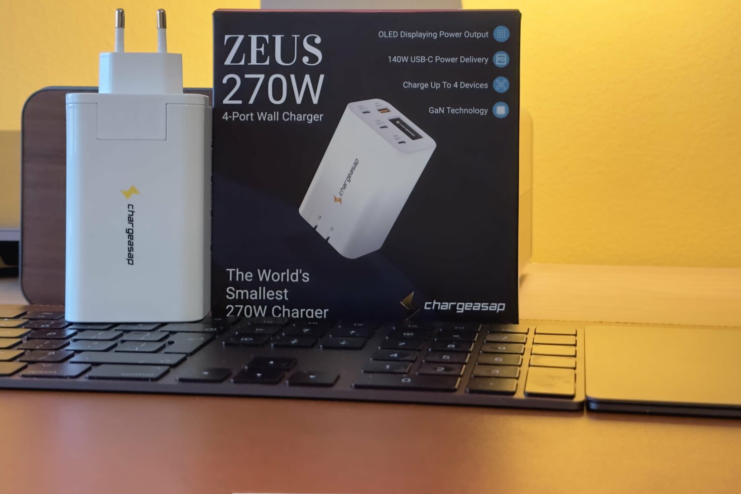 Packaging of the Chargeasap 150W Zeus power adapter on a desk with Apple gear
