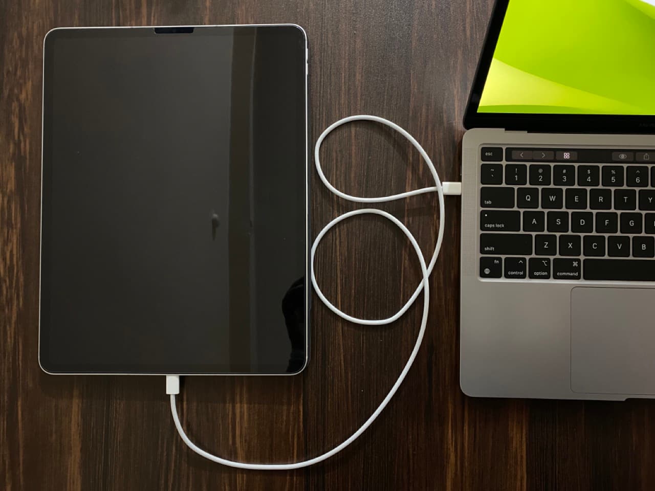 iPad Pro connected to MacBook via USB cable