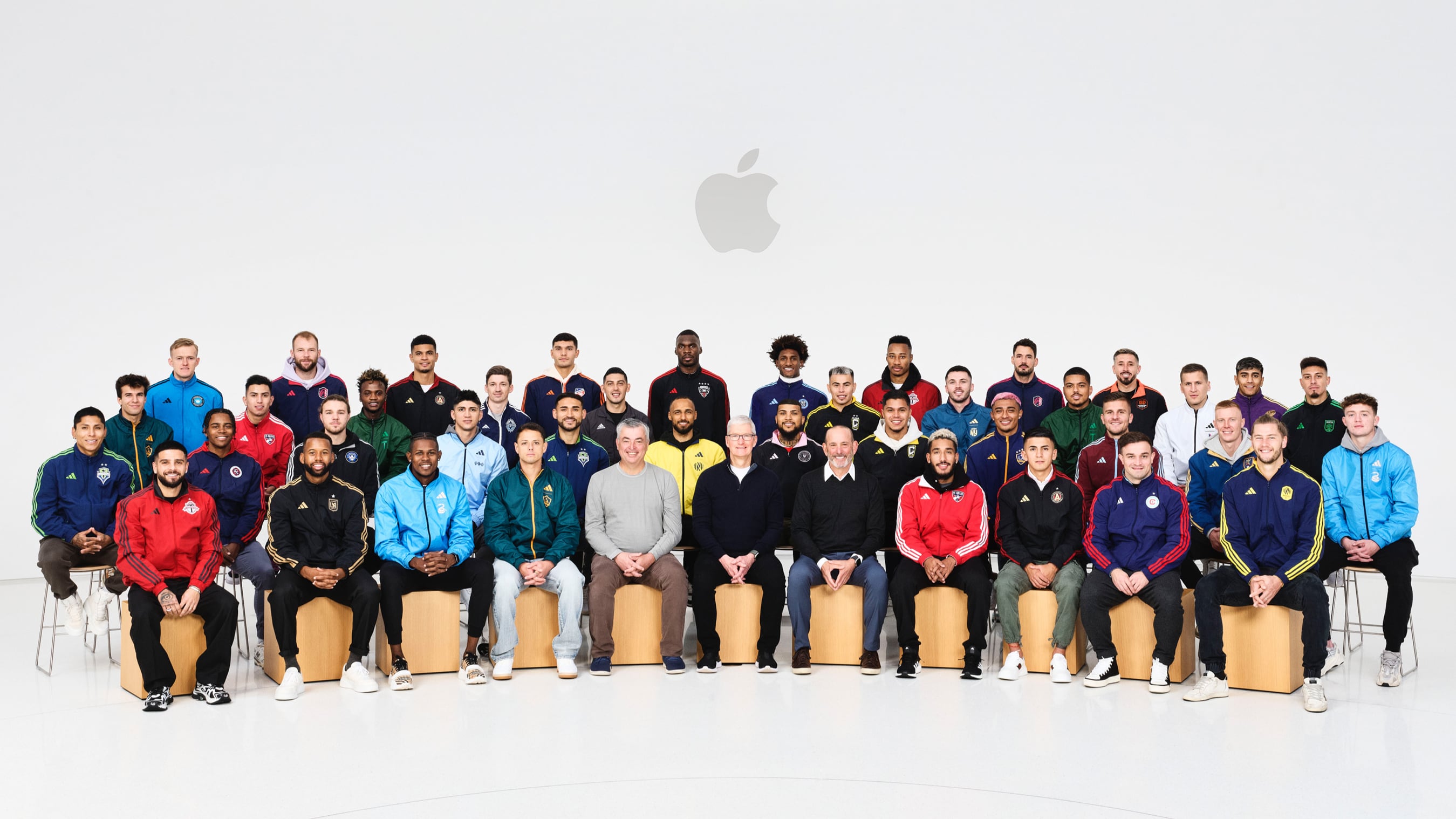 Group photo of Apple's Tim Cook and Eddy Cue with MLS players