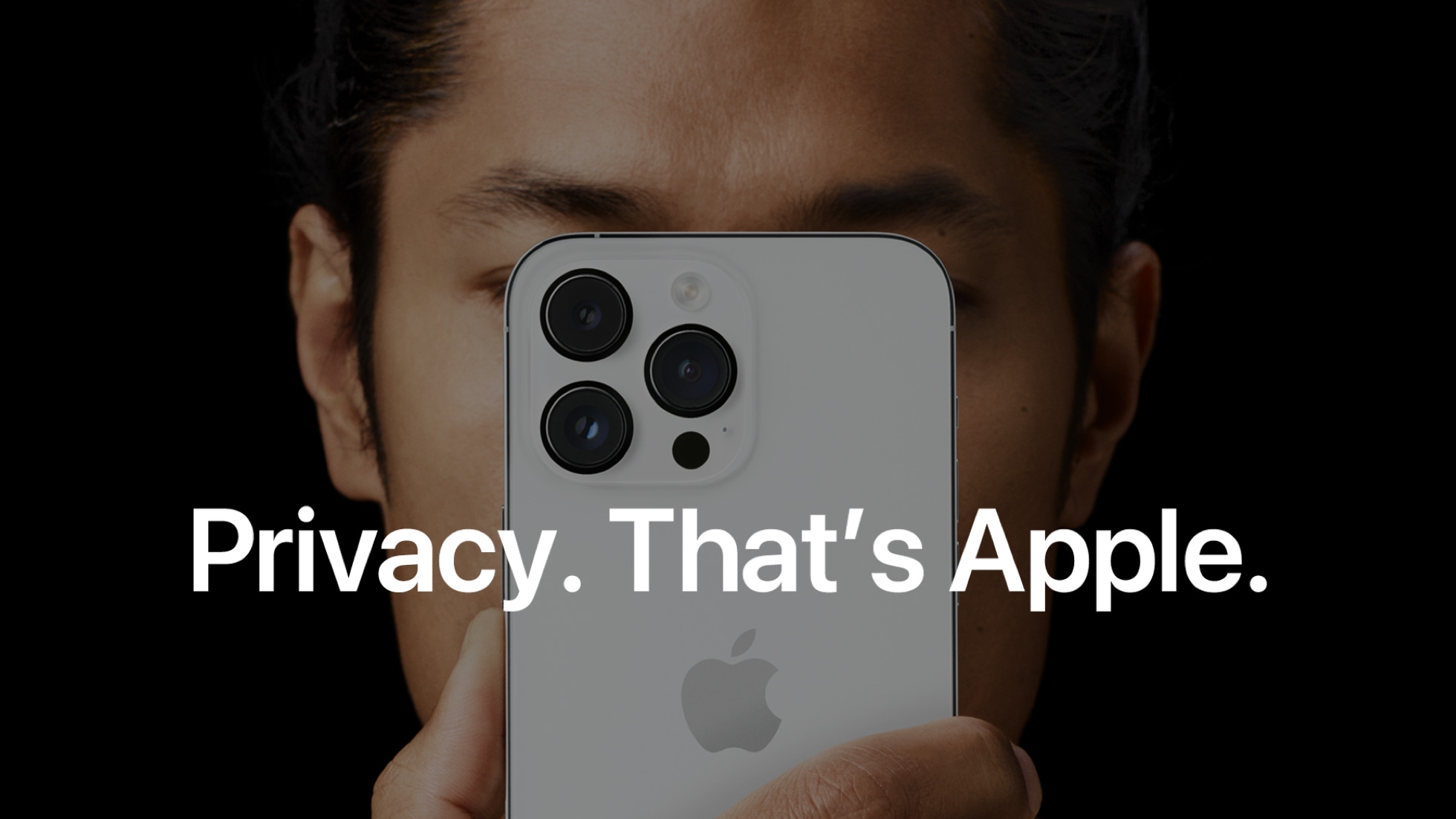Woman holding an iPhone in front of her face. The tagline reads, "Privacy. That's Apple."