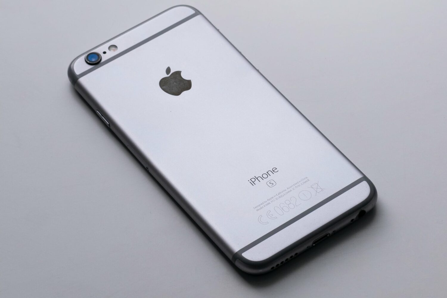 Space gray iPhone 6s facedown on a gray gradient background