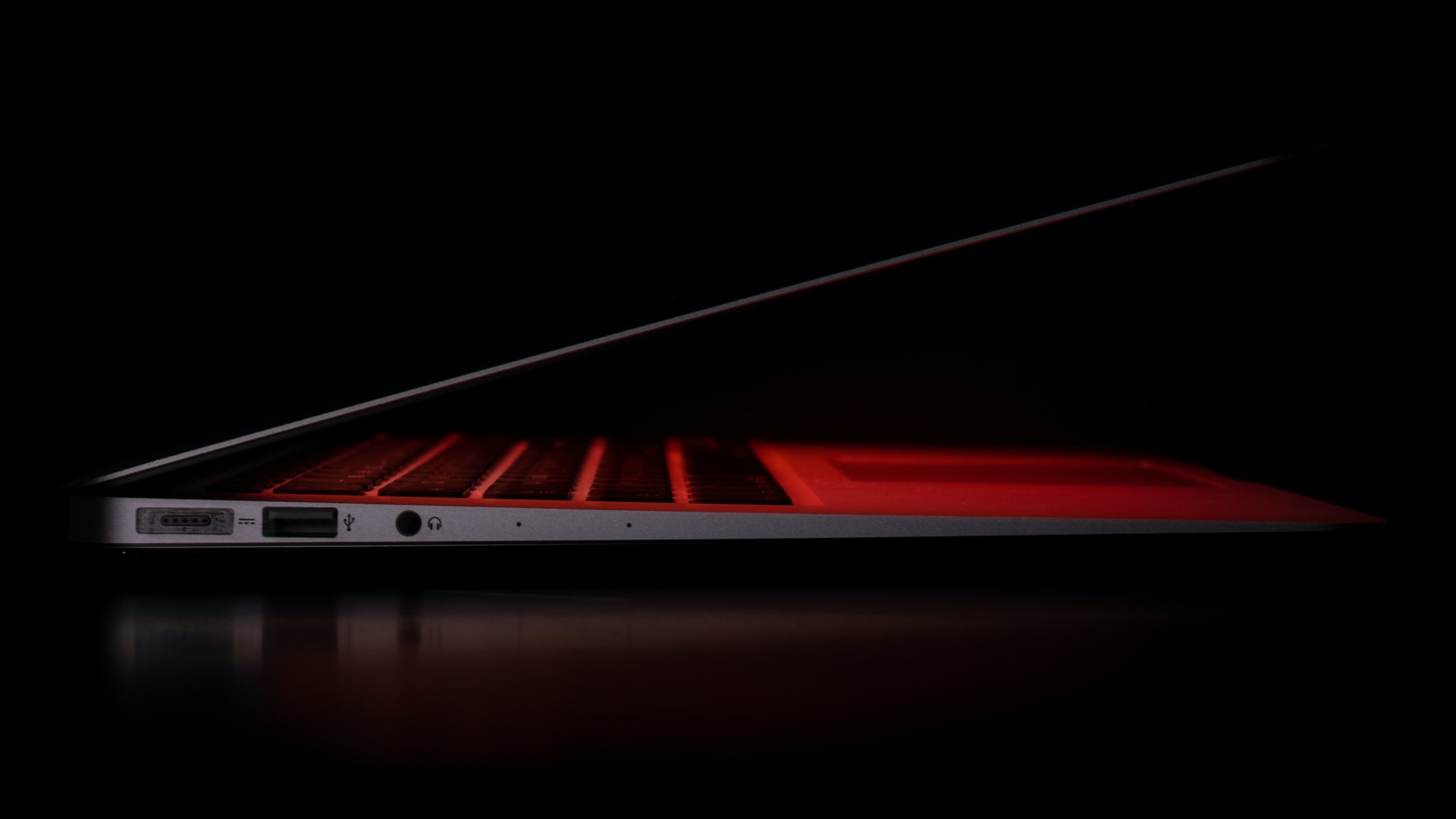 The left side view of Apple's MacBook Air laptop, shot at night