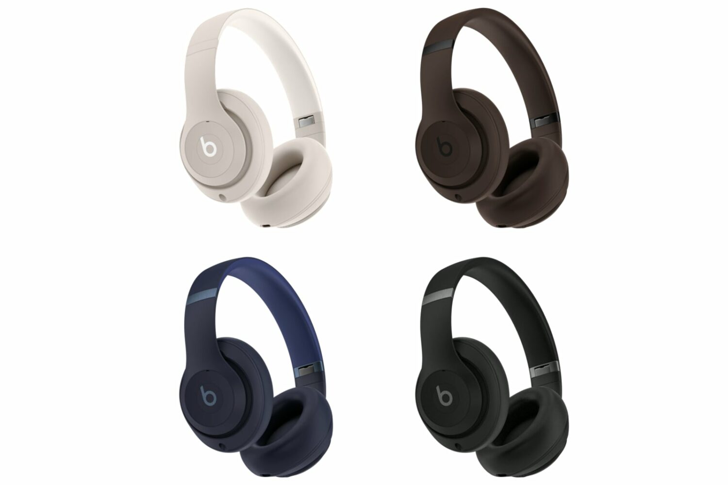 Four Beats Studio Pro over-ear headphones in white, brown, dark blue and black, set against a white background