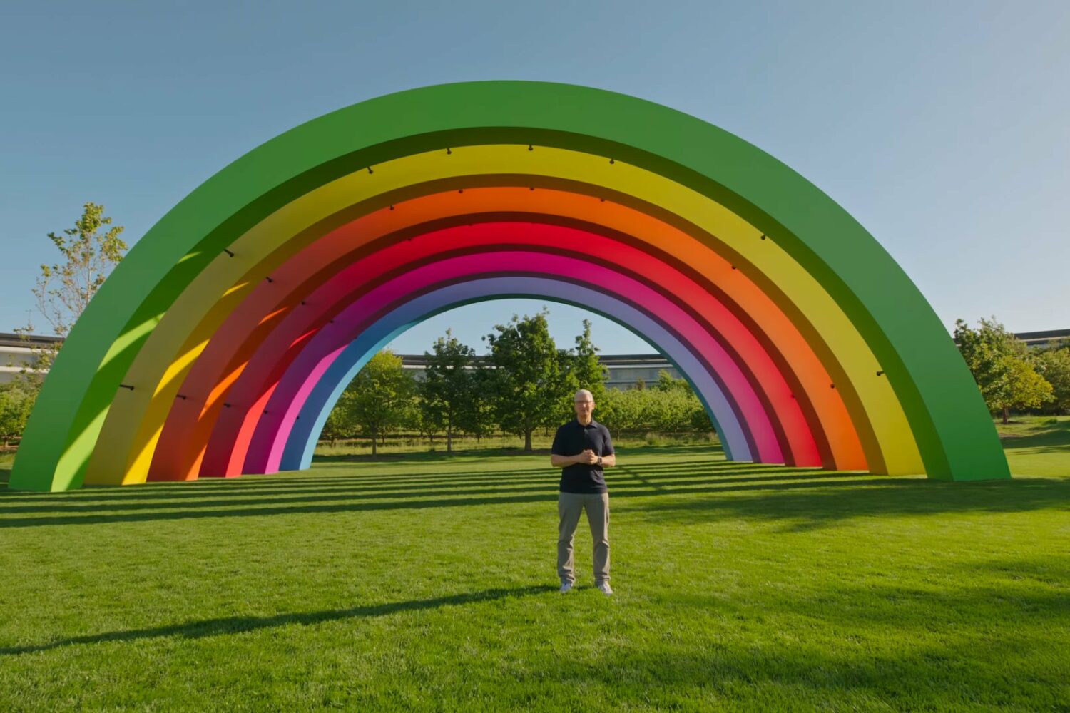 Tim Cook standing in front of the Apple Park's rainbow Stage